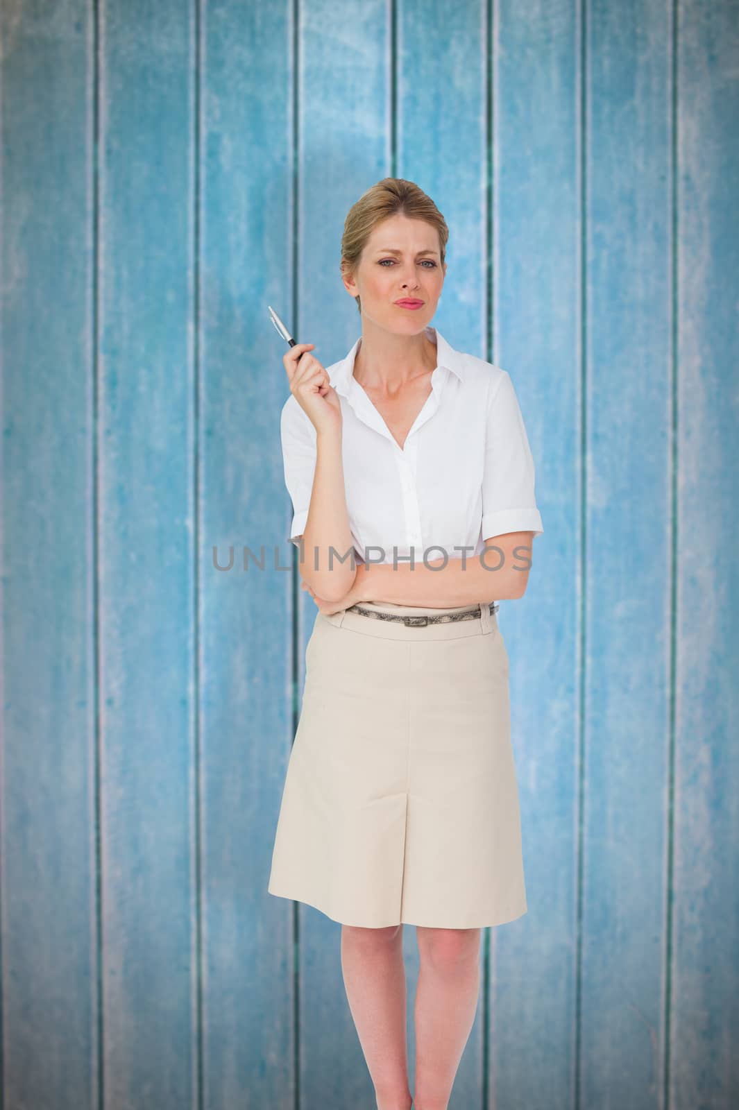 Thinking businesswoman against wooden planks