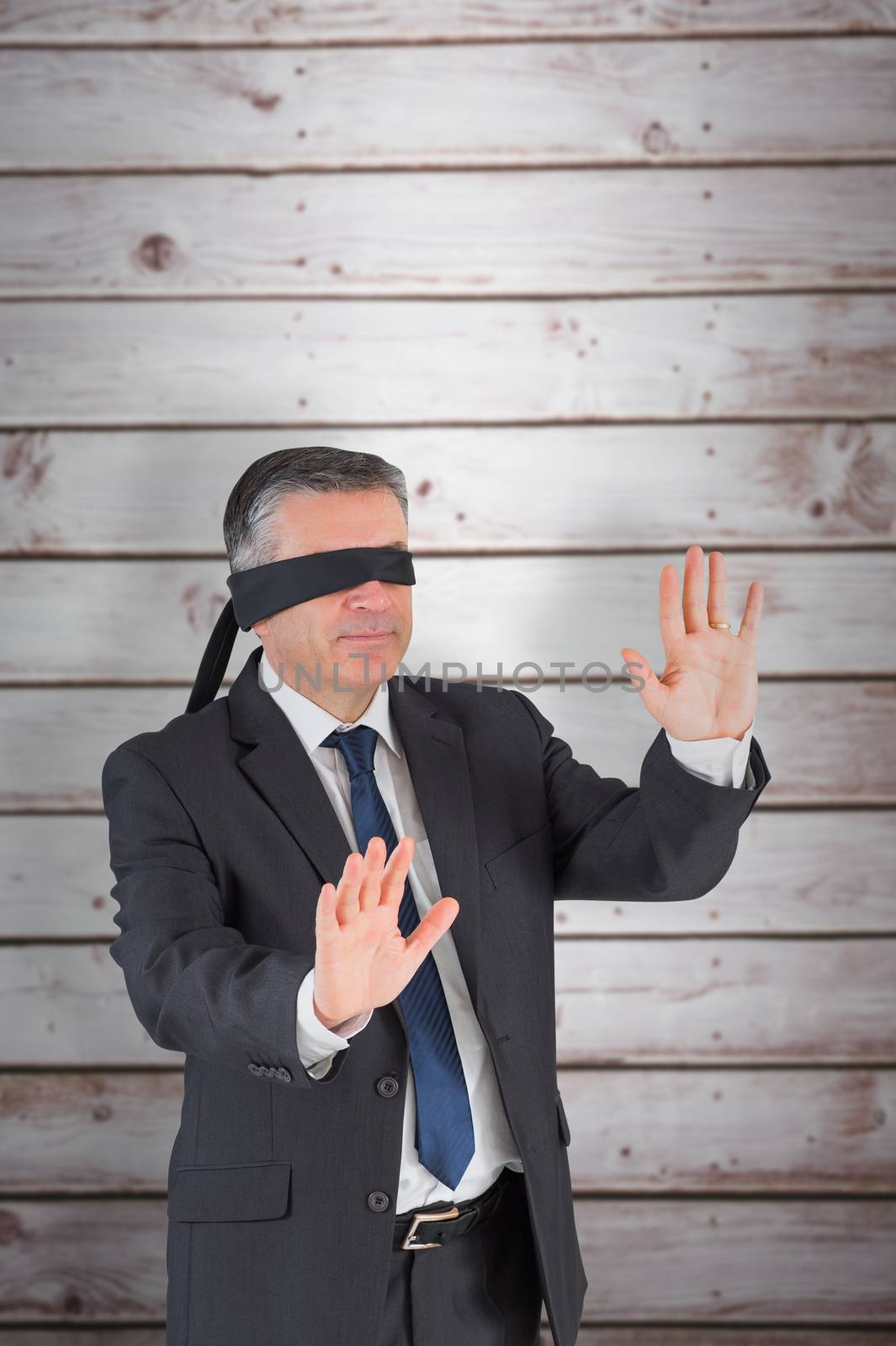 Composite image of mature businessman in a blindfold by Wavebreakmedia