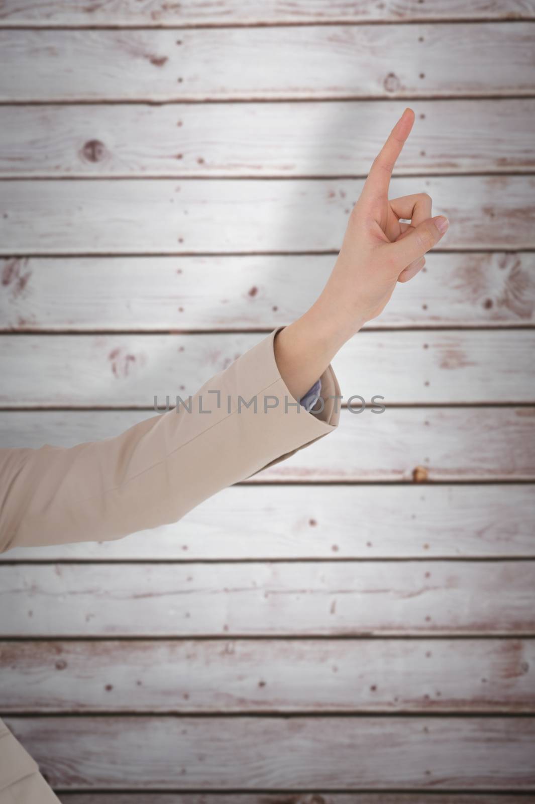 Businesswoman pointing against wooden planks