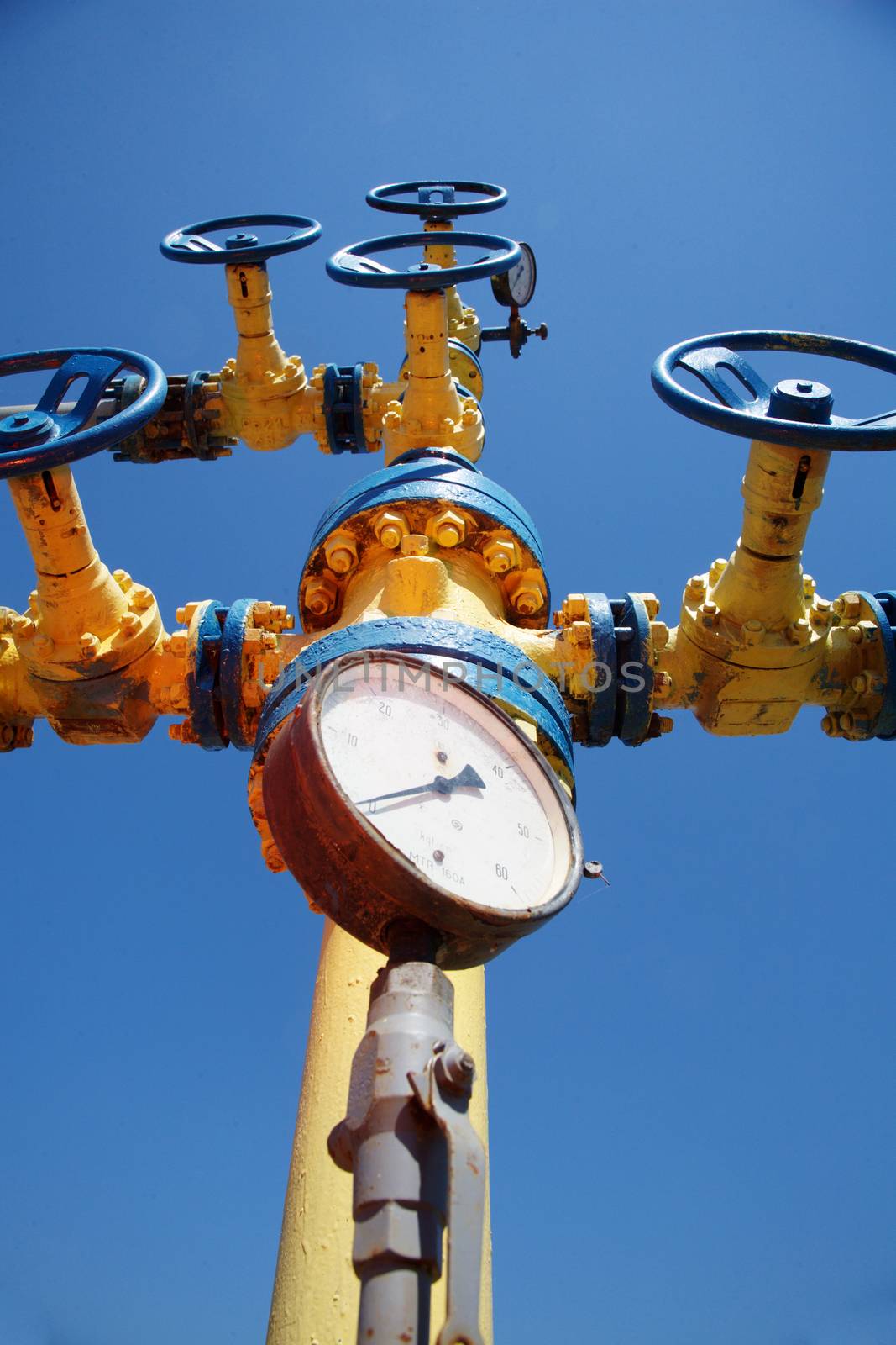 Steel pipeline with valves against blue sky