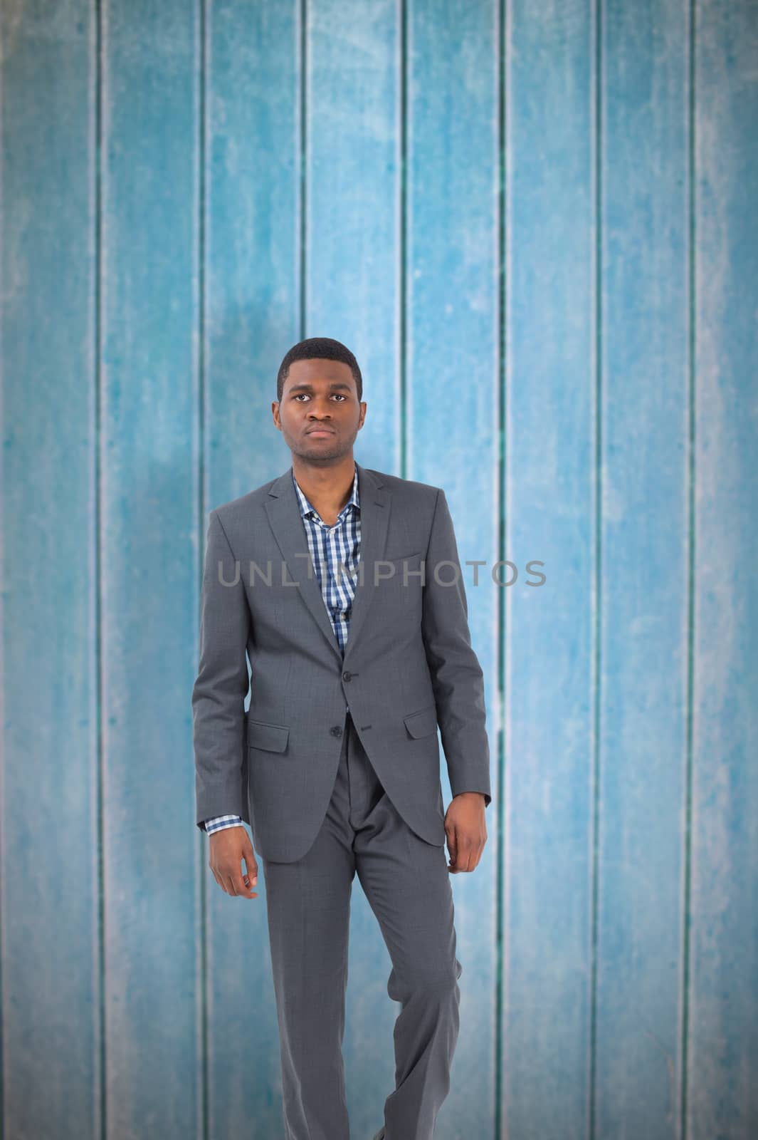 Composite image of businessman standing looking at camera by Wavebreakmedia