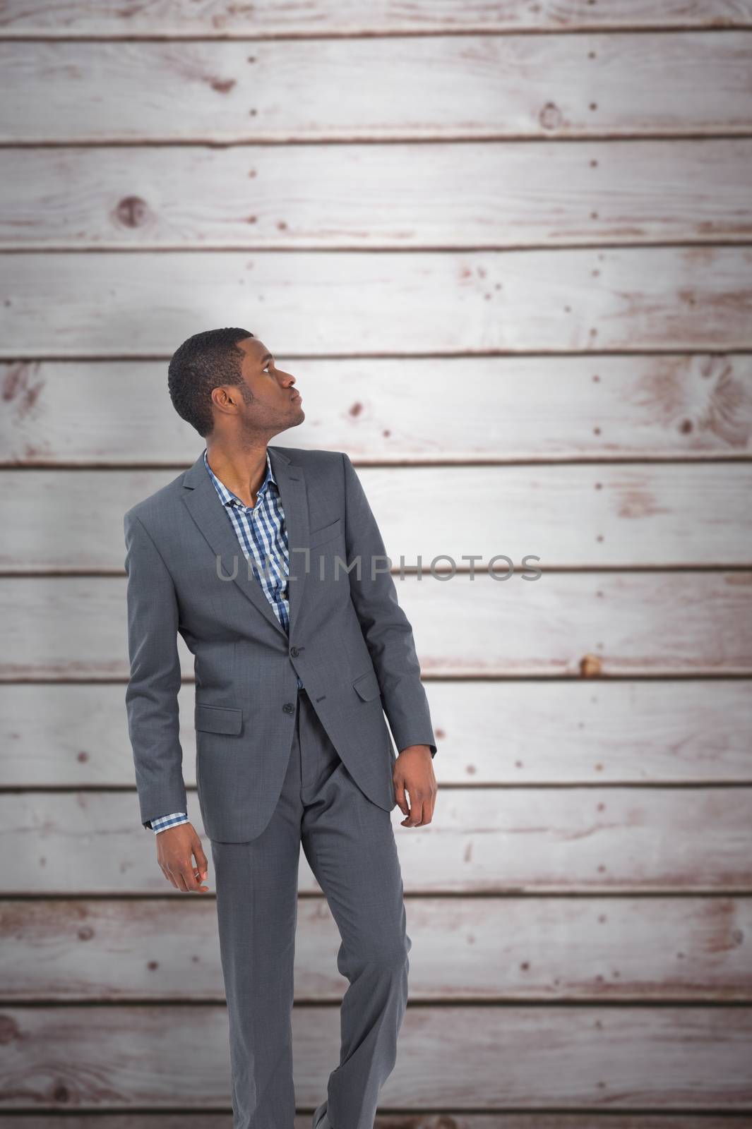 Composite image of businessman standing and looking by Wavebreakmedia