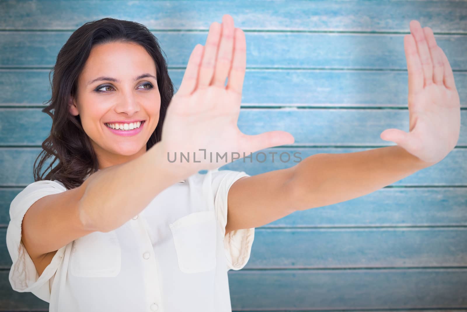 Composite image of pretty brunette holding up hands by Wavebreakmedia