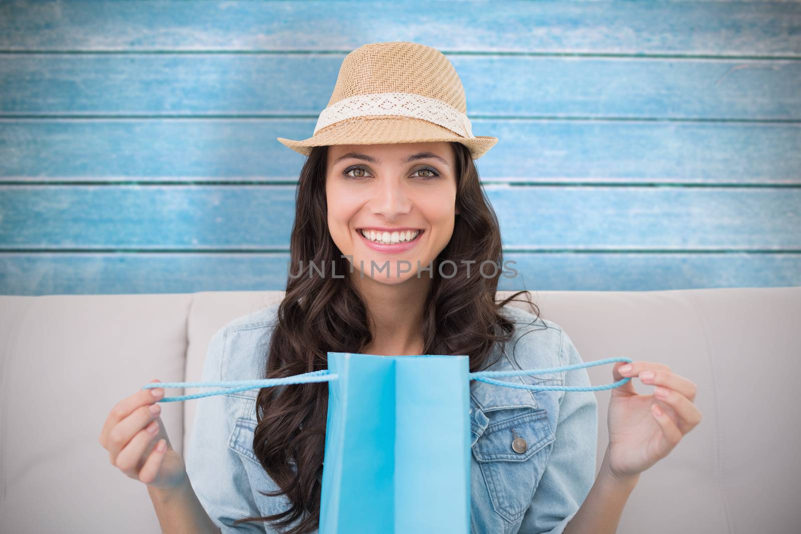 Brunette with shopping bag against wooden planks