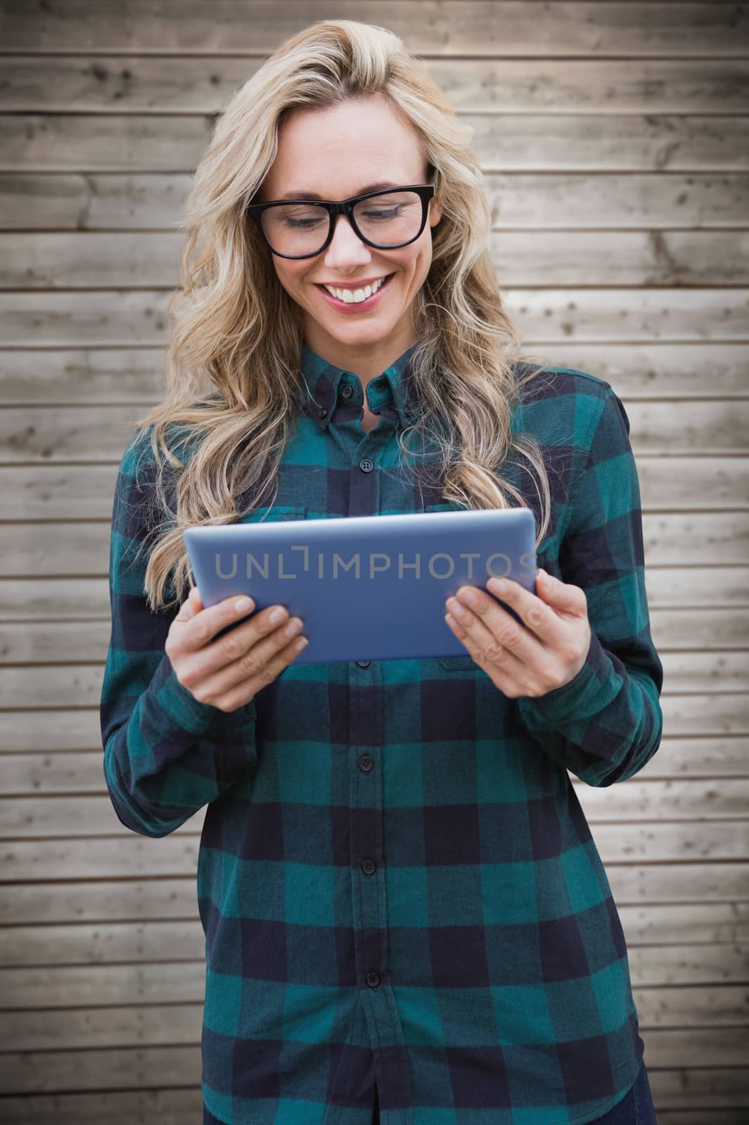 Composite image of pretty blonde with tablet by Wavebreakmedia