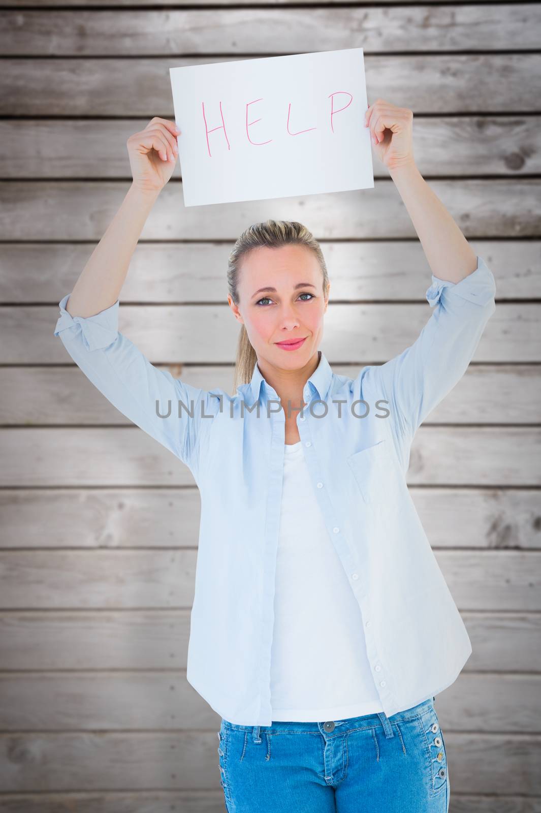 Pretty blonde holding help sign  against wooden planks