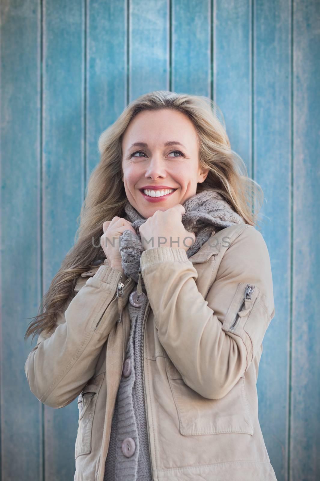 Smiling blonde against wooden planks