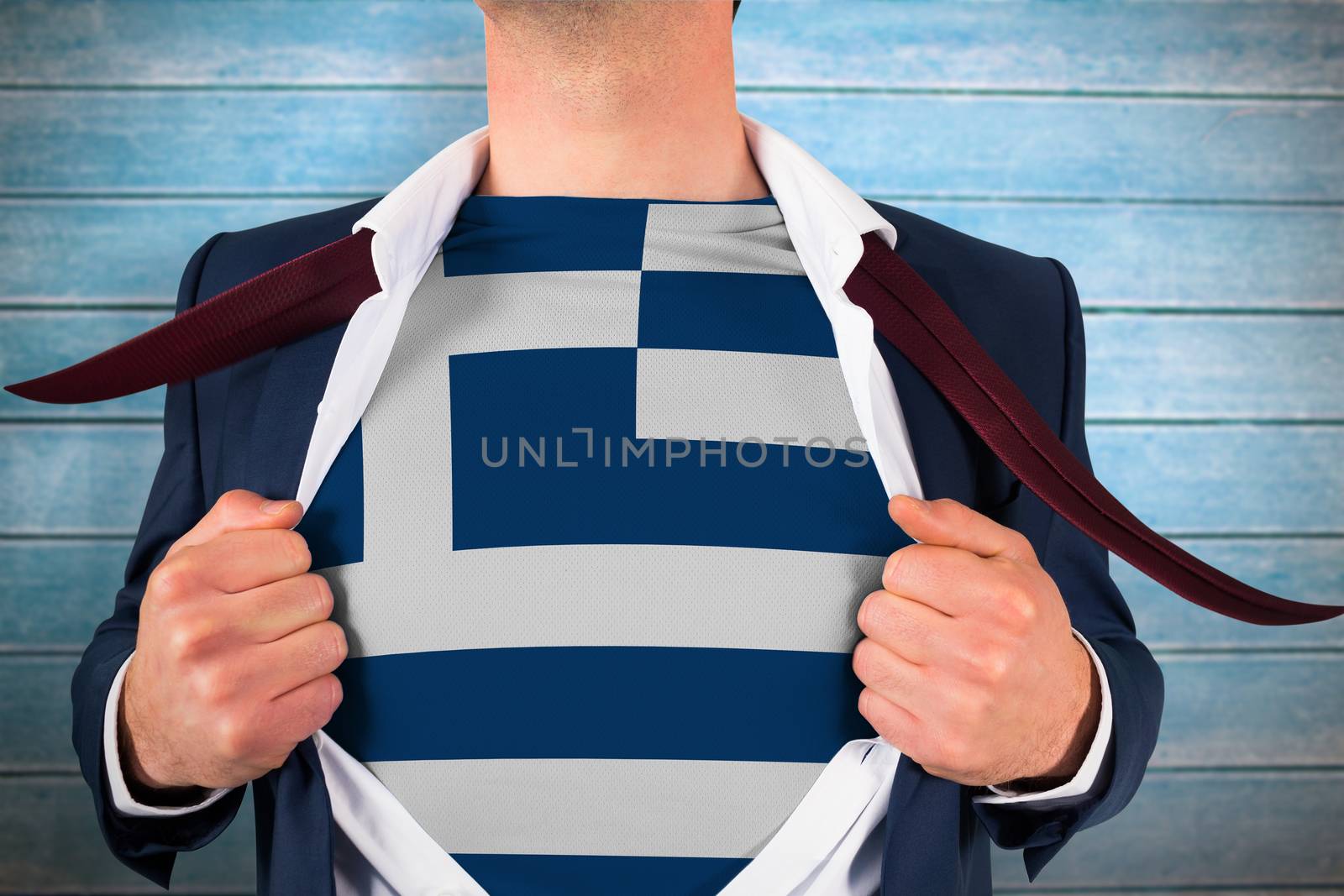 Businessman opening shirt to reveal greece flag against wooden planks