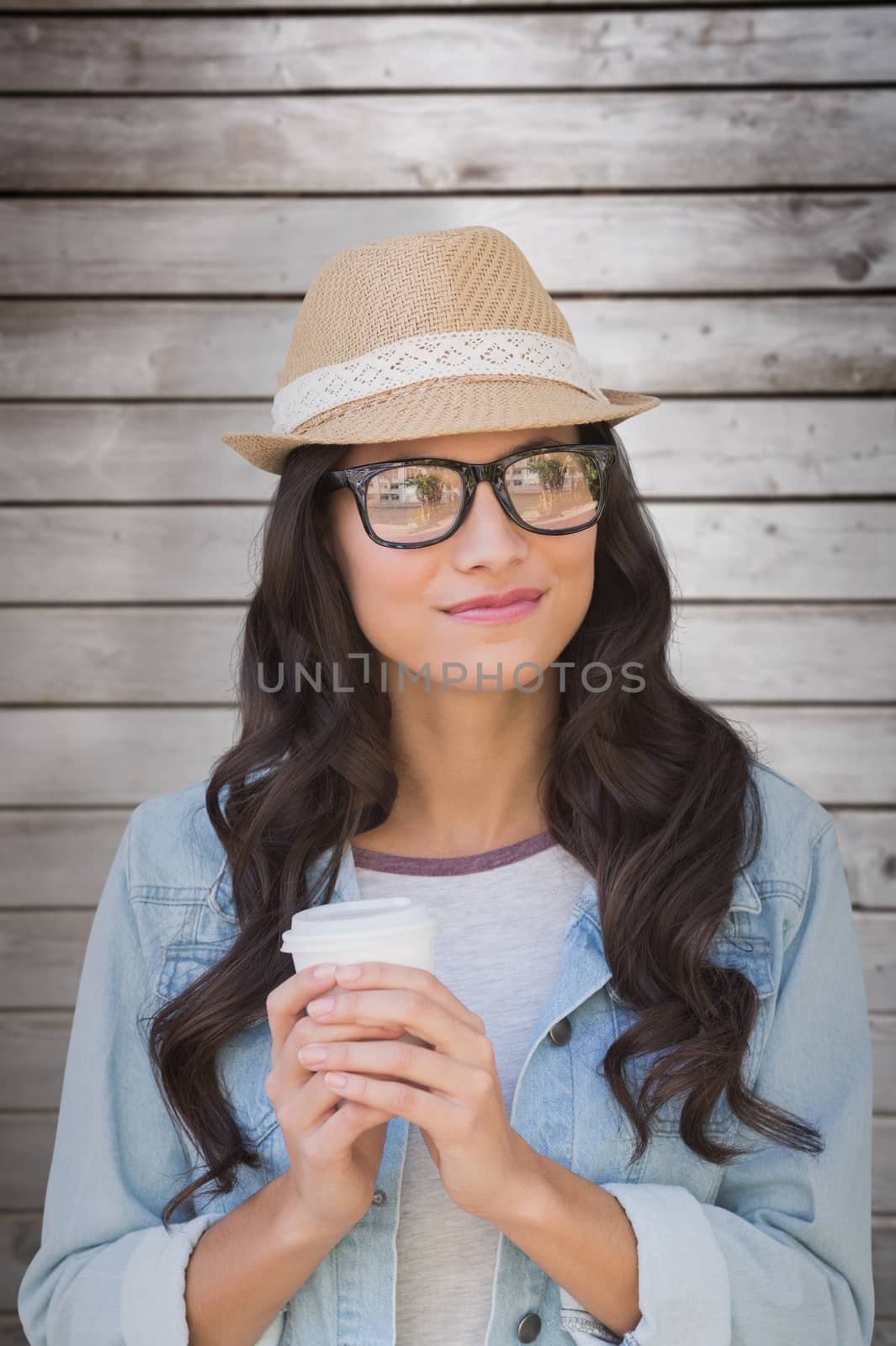 Composite image of brunette with disposable cup by Wavebreakmedia