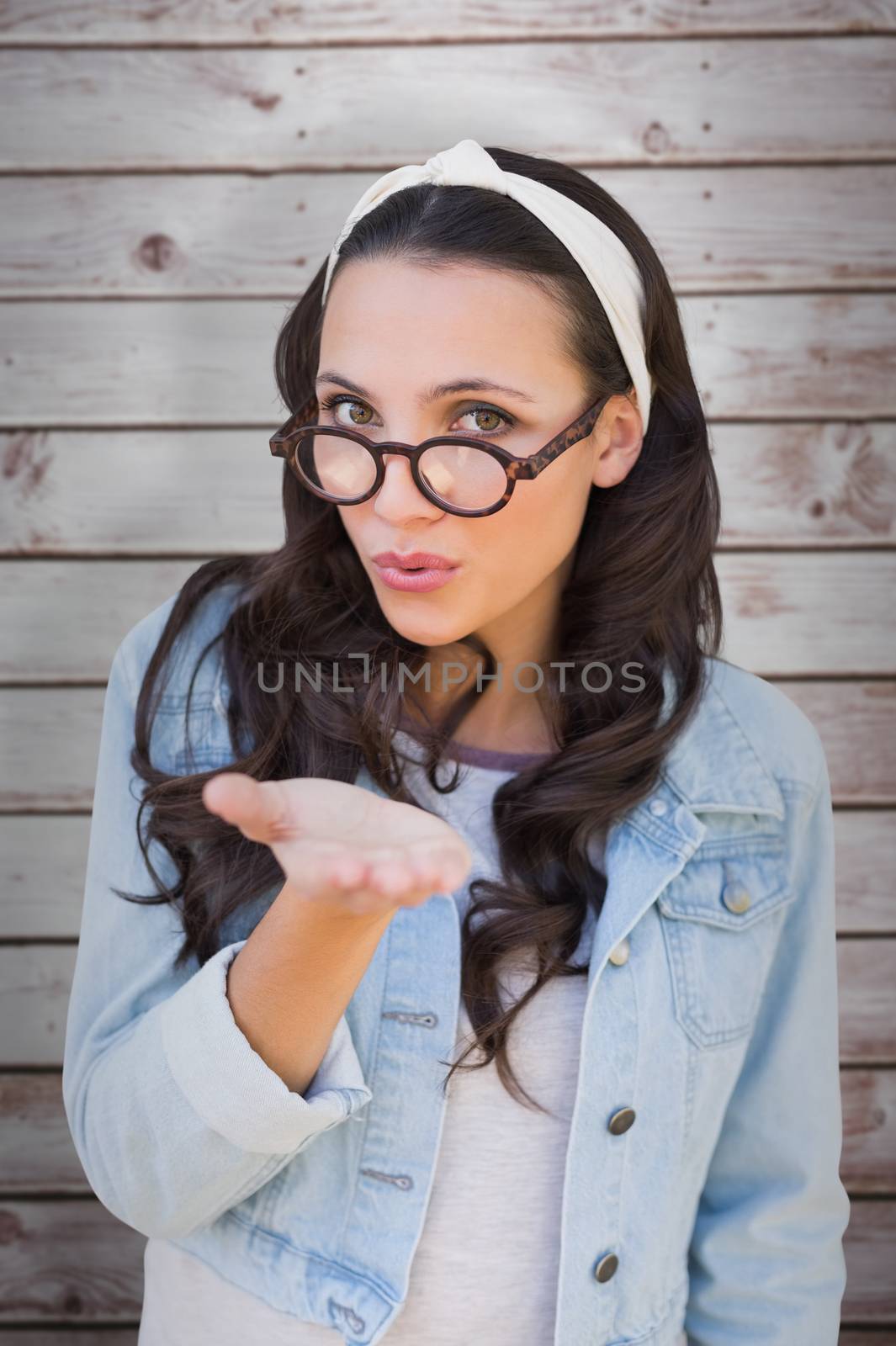 Composite image of brunette blowing kiss by Wavebreakmedia