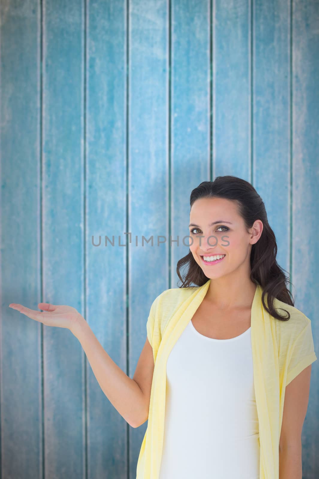 Composite image of pretty brunette smiling at camera by Wavebreakmedia