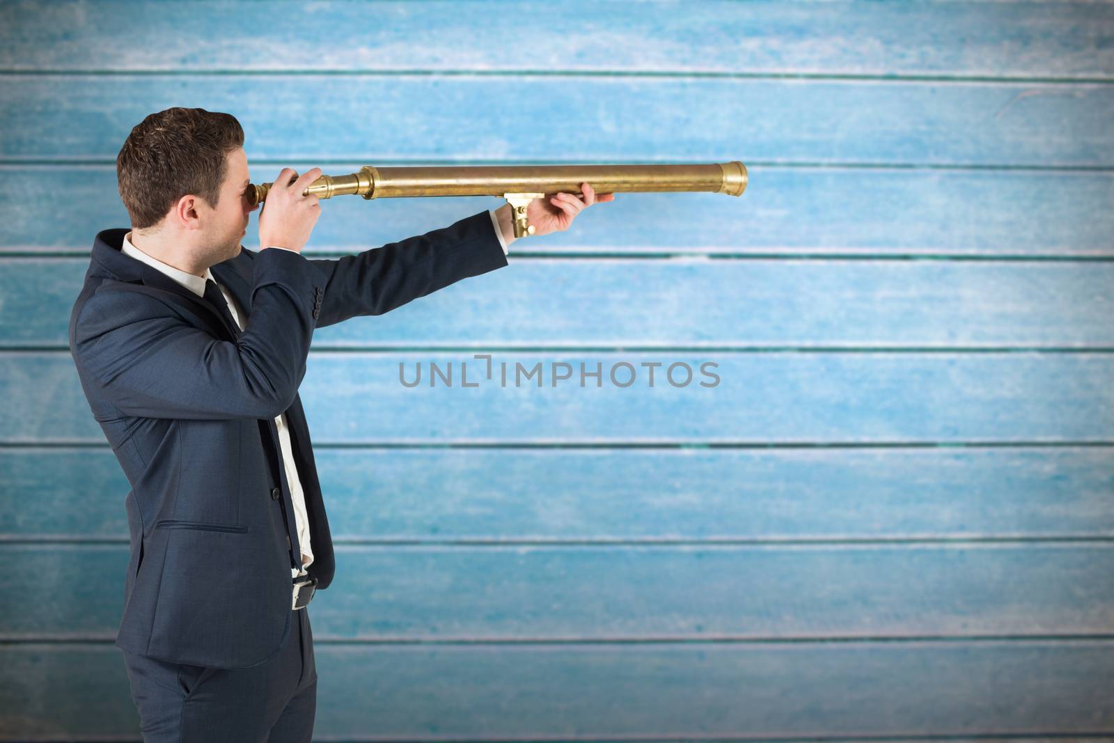 Businessman looking through telescope against wooden planks