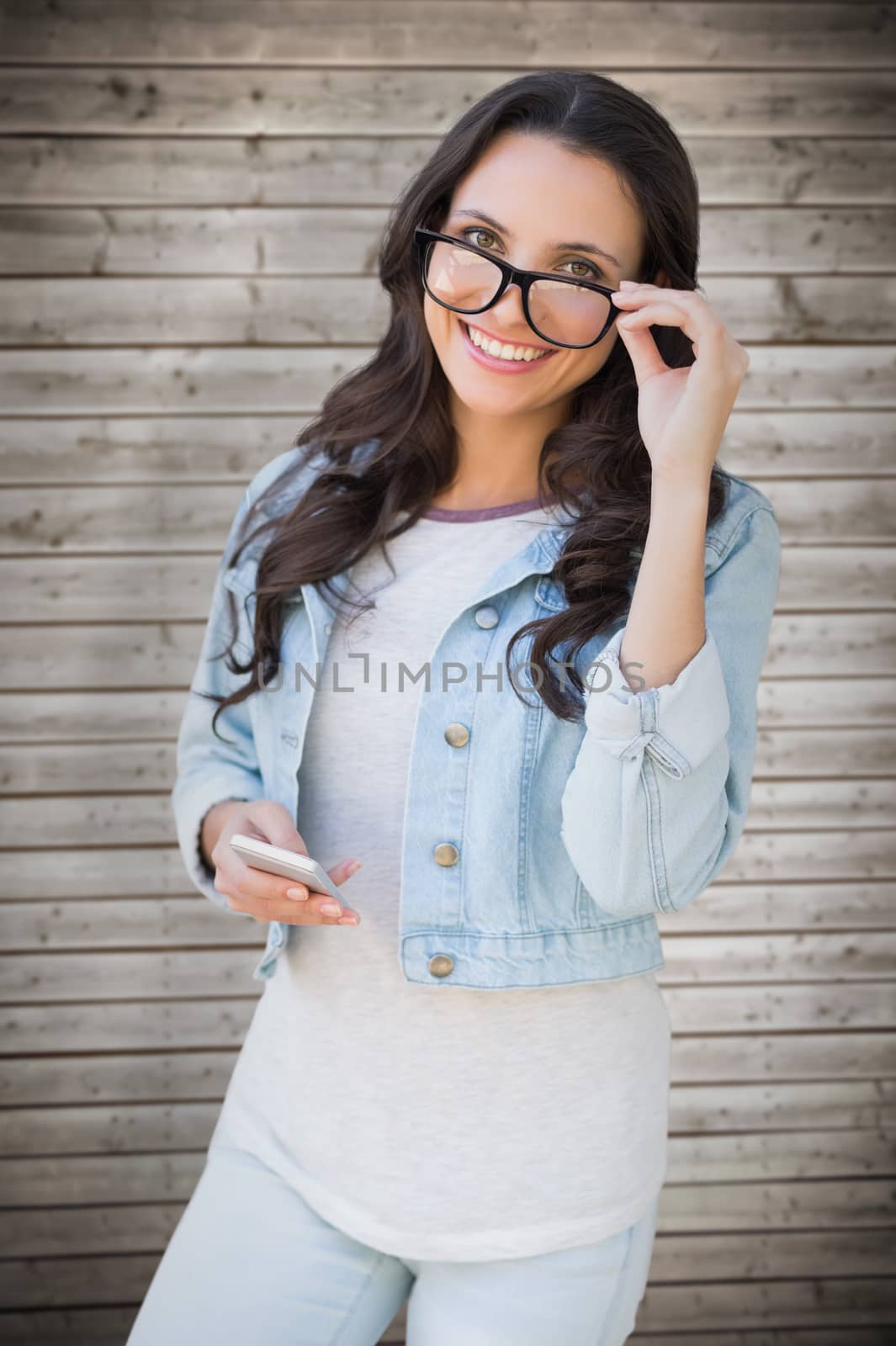 Composite image of brunette with smartphone by Wavebreakmedia