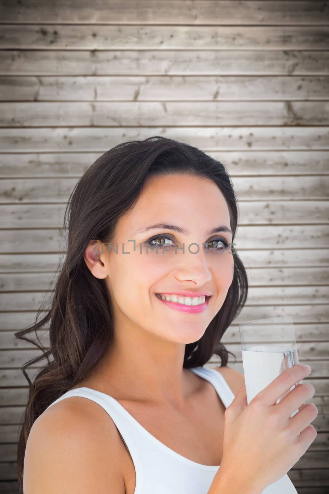 Composite image of pretty brunette drinking glass of water by Wavebreakmedia