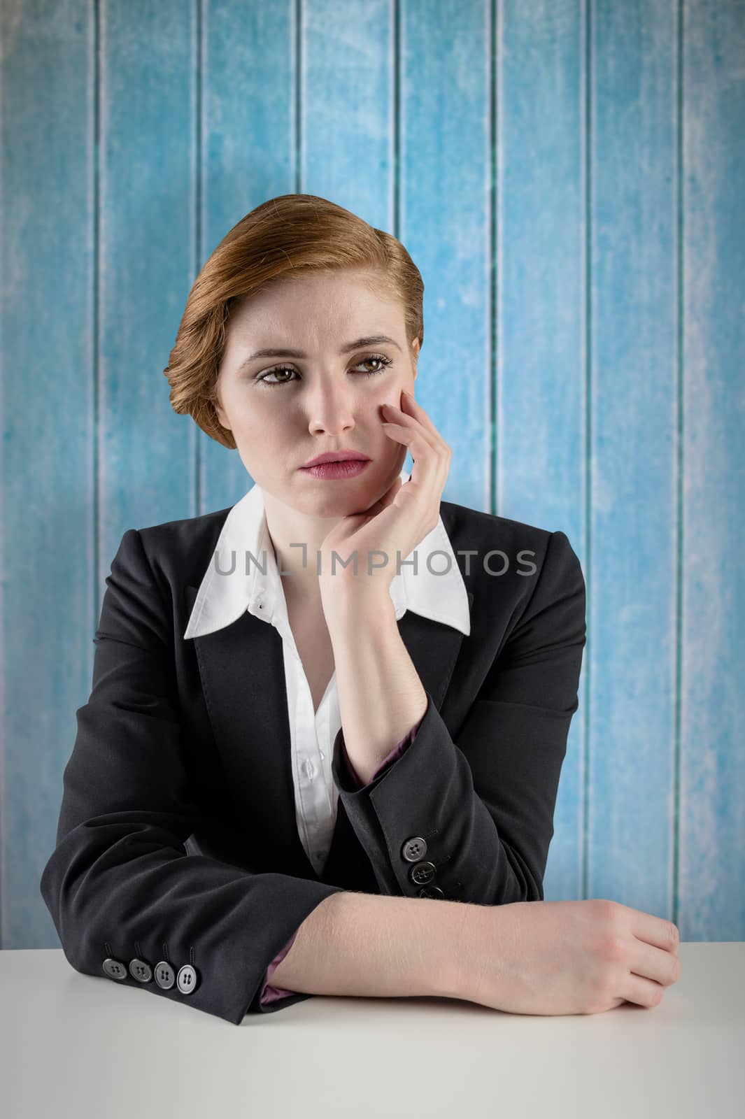 Composite image of thinking redhead businesswoman by Wavebreakmedia