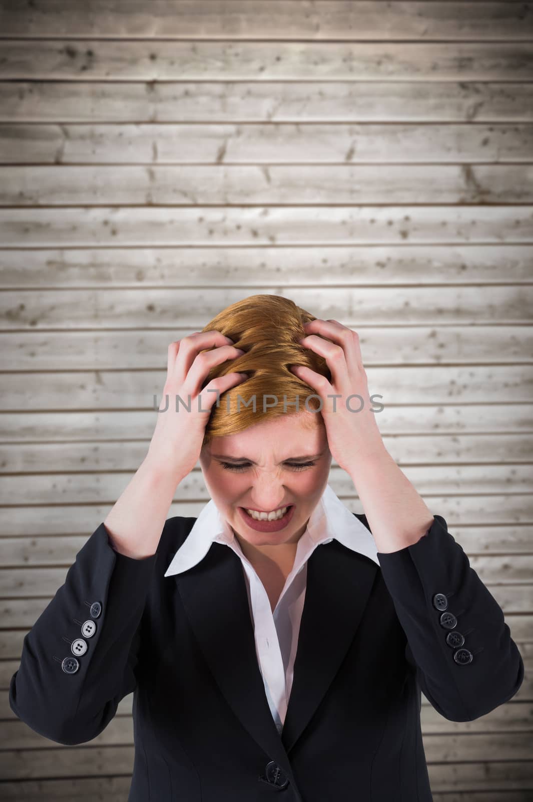 Stressed businesswoman with hands on her head against wooden planks background