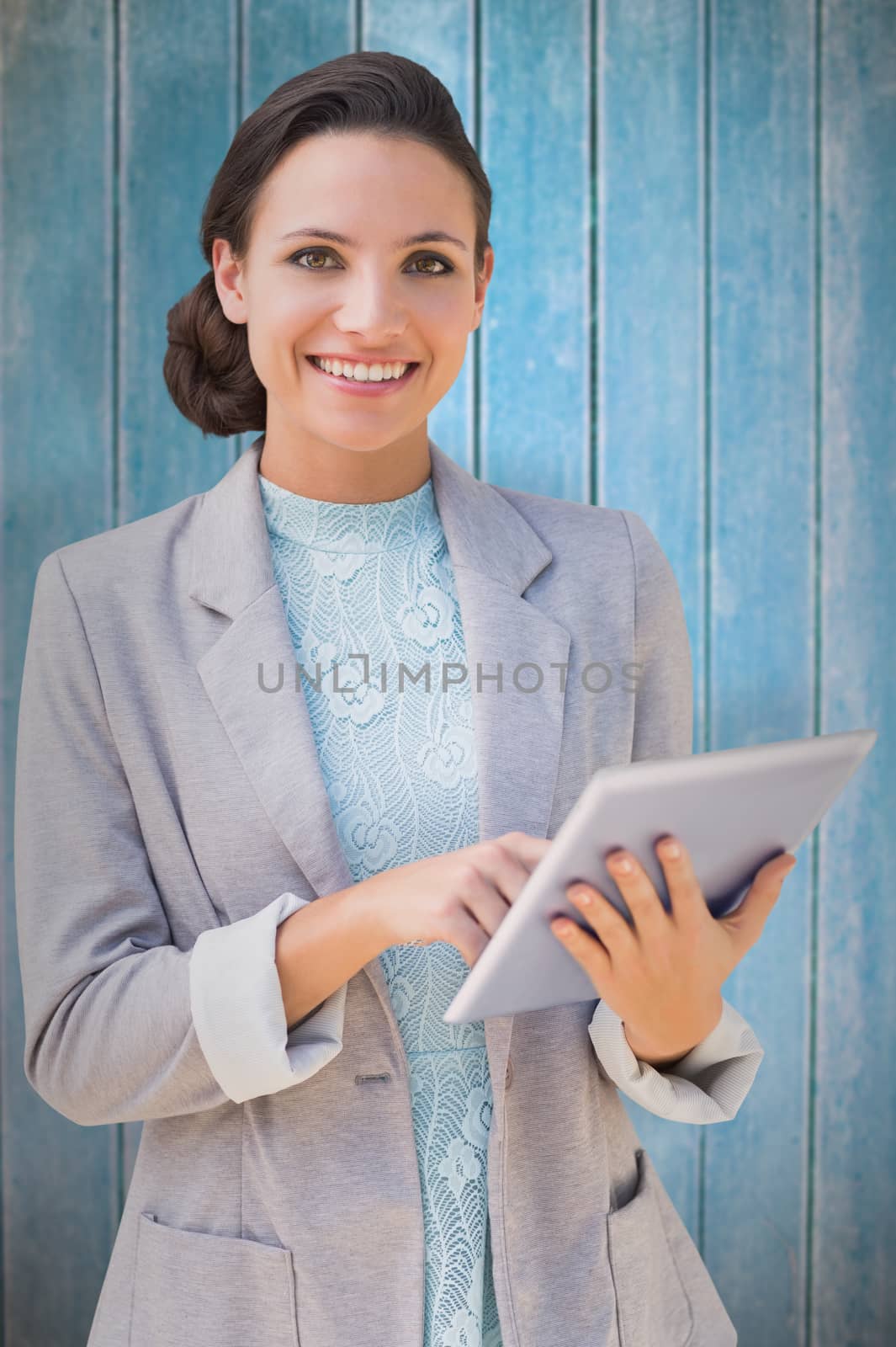 Composite image of brunette using tablet pc by Wavebreakmedia