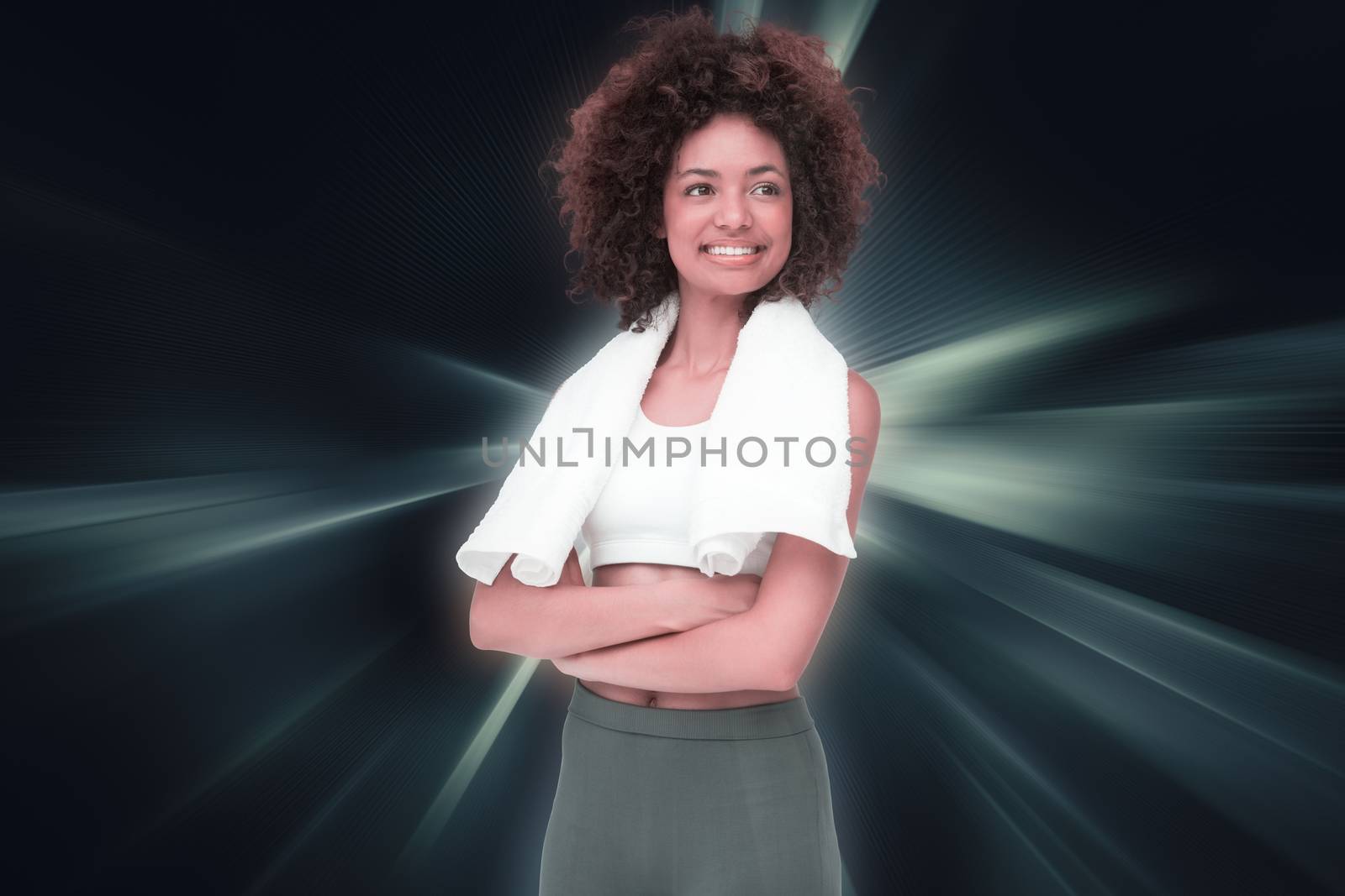 Smiling fit young woman with towel against abstract background