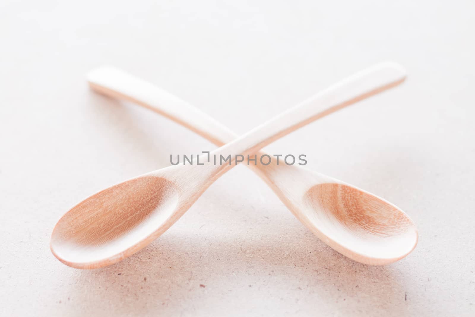 Empty spoons on brown background, stock photo