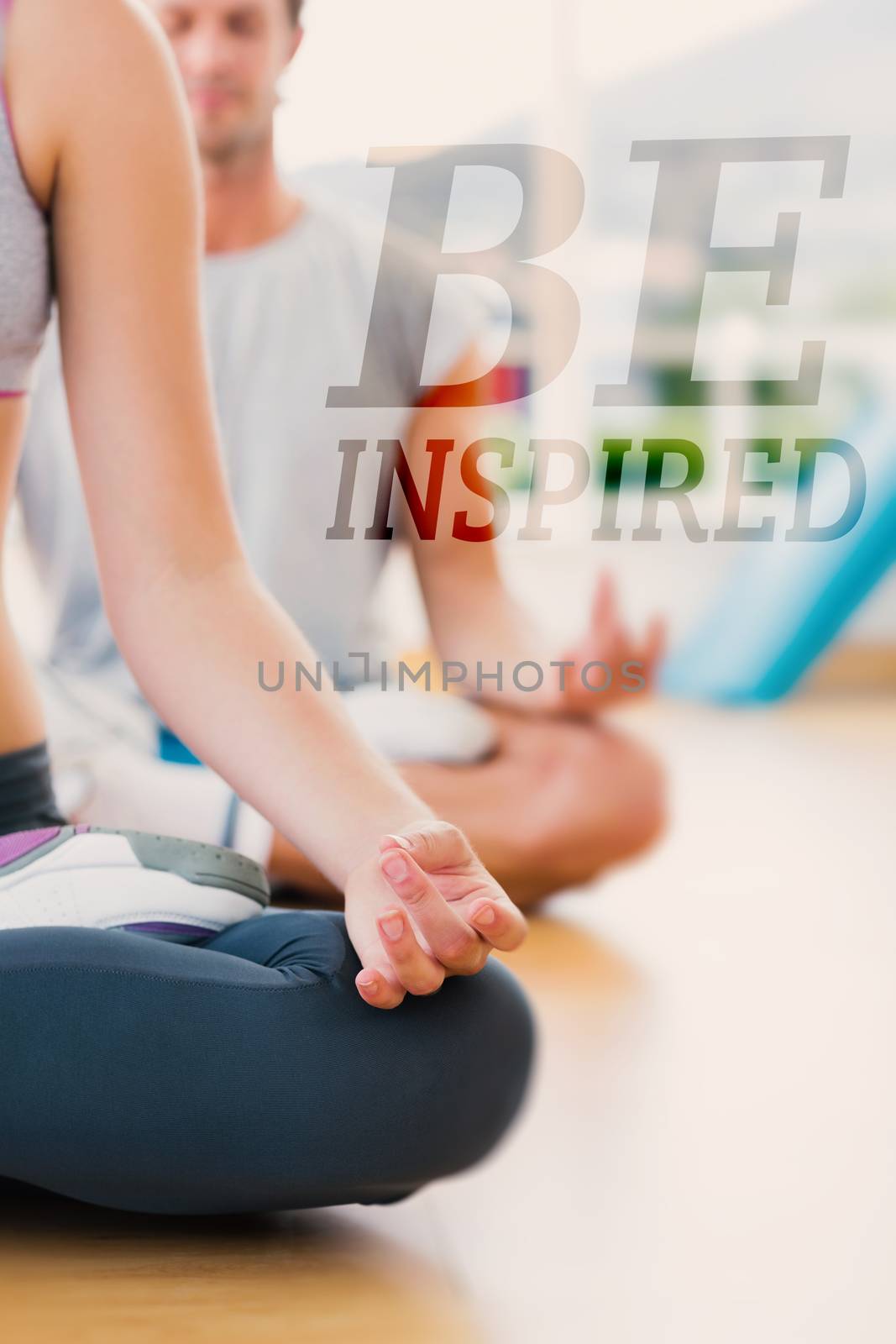 Cropped couple in meditation pose at fitness studio against be inspired