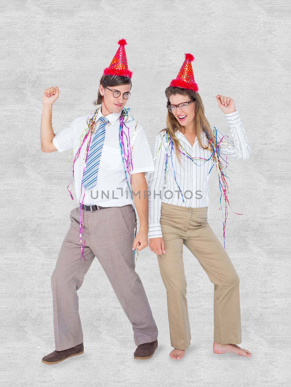 Happy geeky couple dancing  against white background