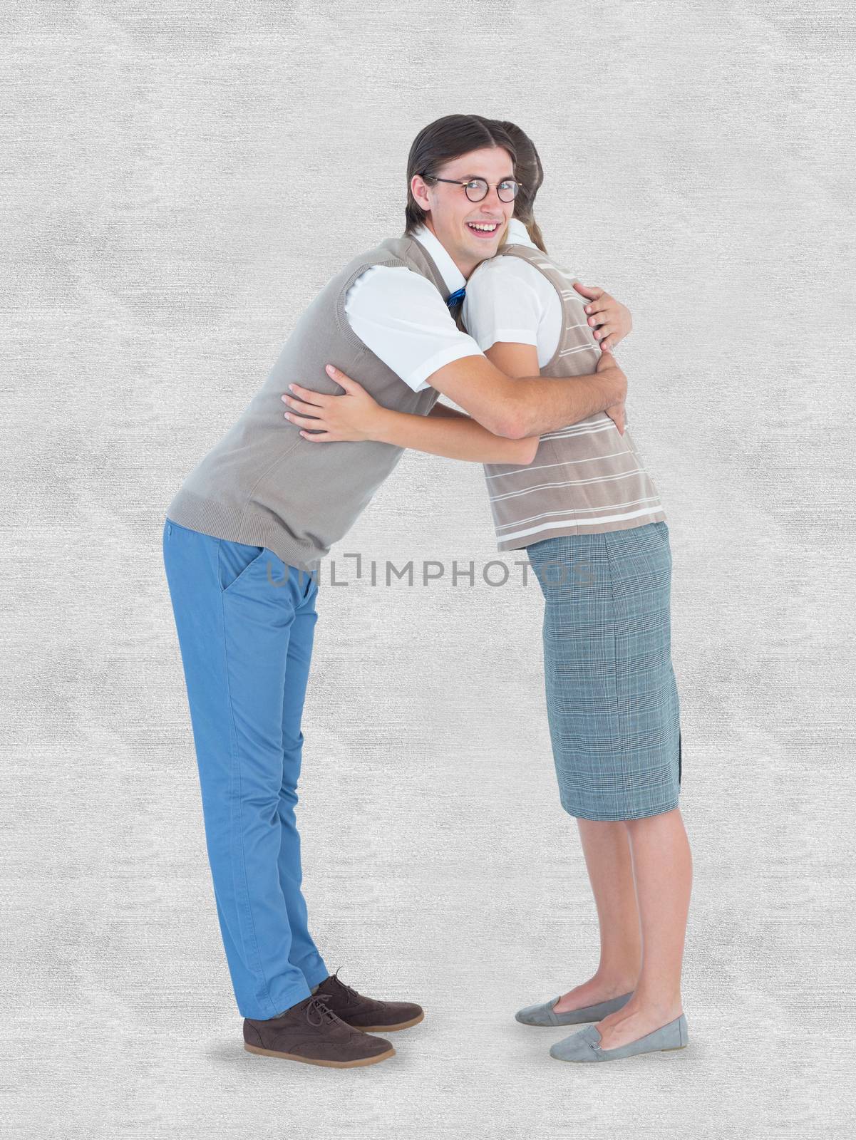 Geeky hipster couple hugging  against white background