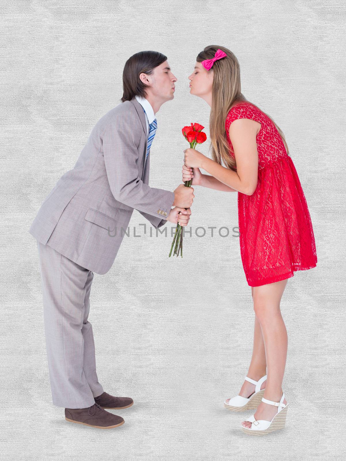 Composite image of cute geeky couple kissing by Wavebreakmedia