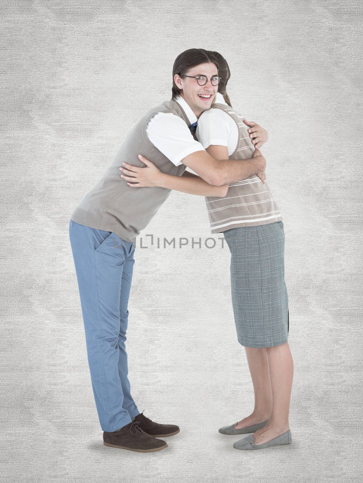 Geeky hipster couple hugging  against white background