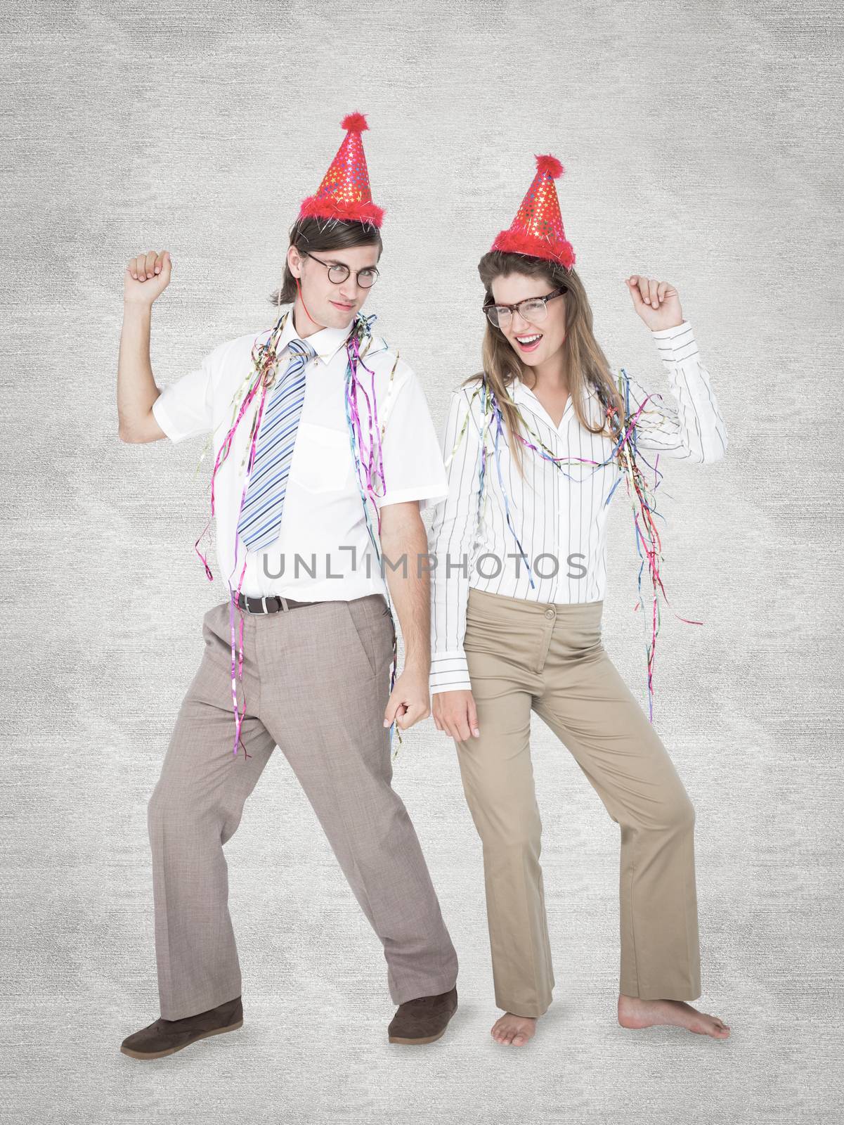 Happy geeky couple dancing  against white background