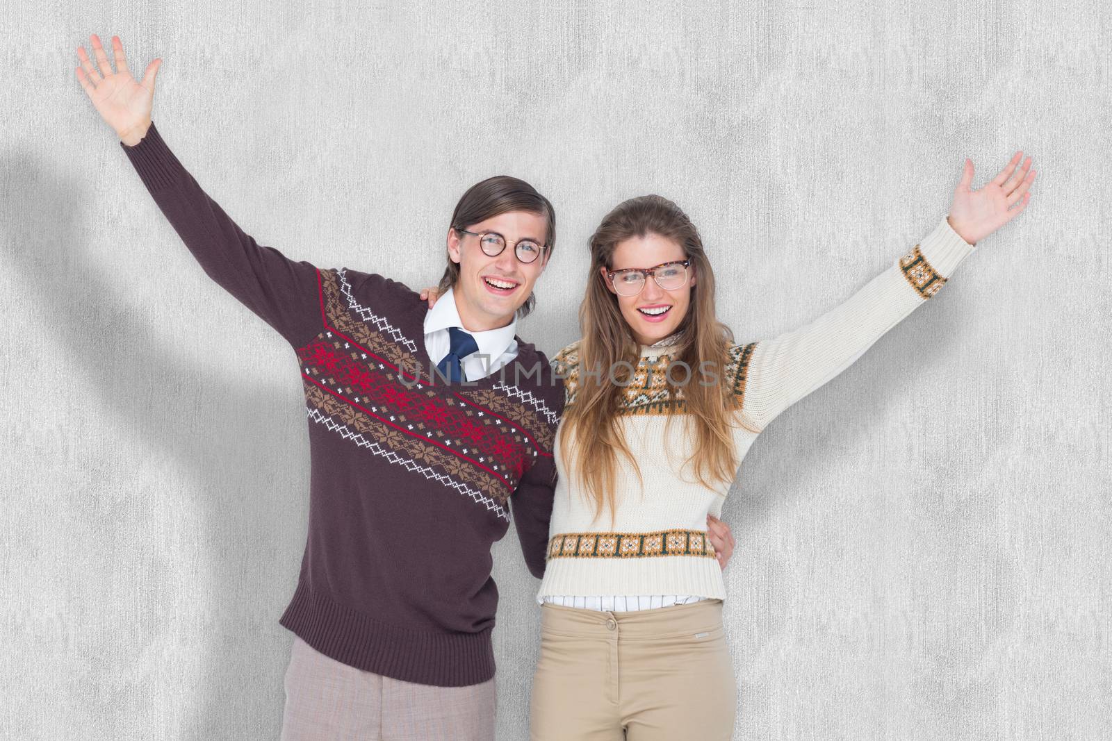 Happy geeky hipster couple embracing against white background