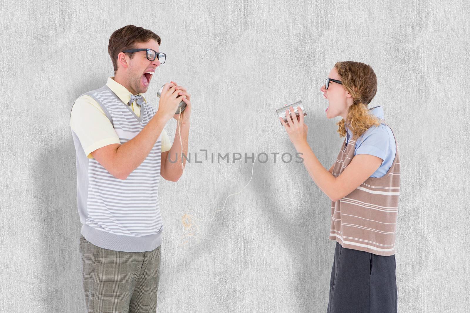 Geeky hipster couple speaking with tin can phone  against white background