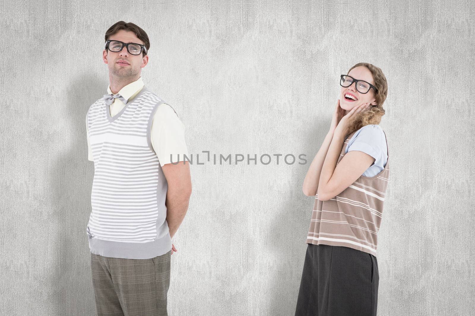 Geeky hipster couple looking at camera  against white background