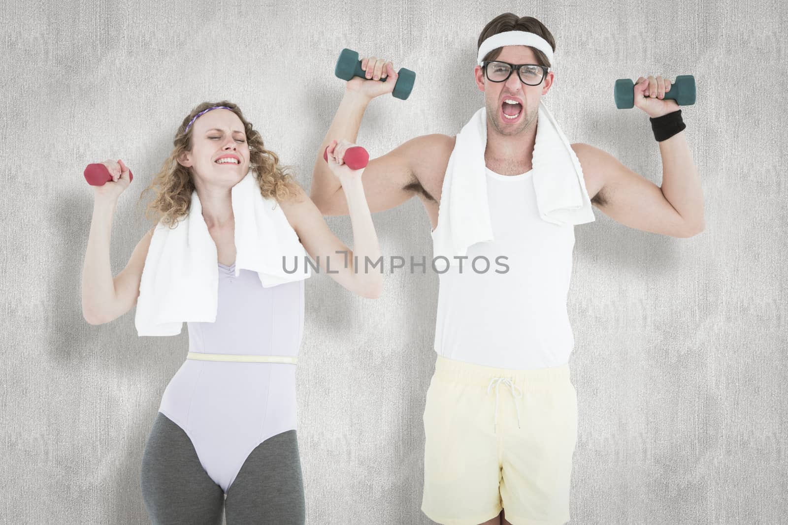 Geeky hipster couple lifting dumbbells in sportswear  against white background