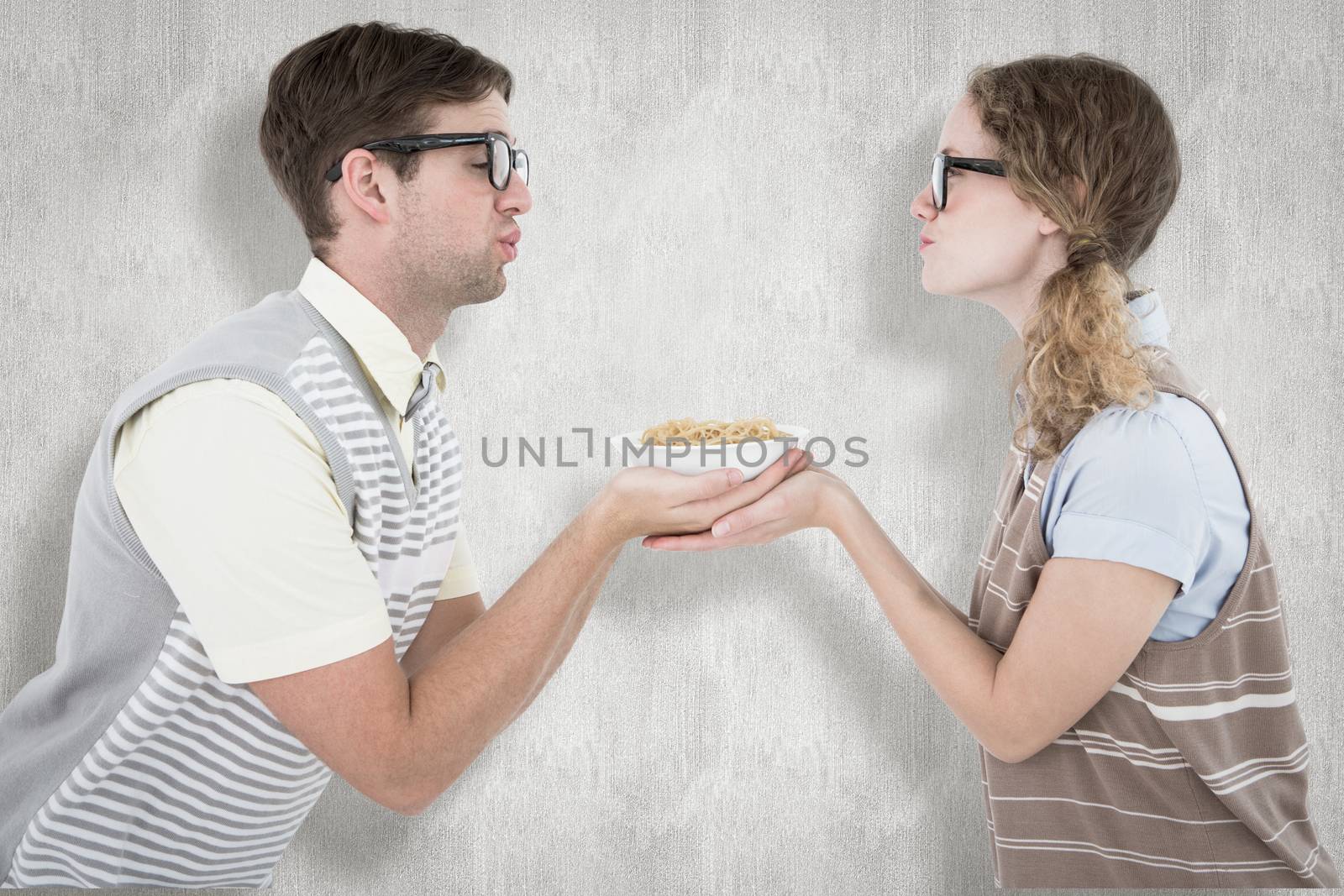 Geeky hipster couple holding pasta against white background