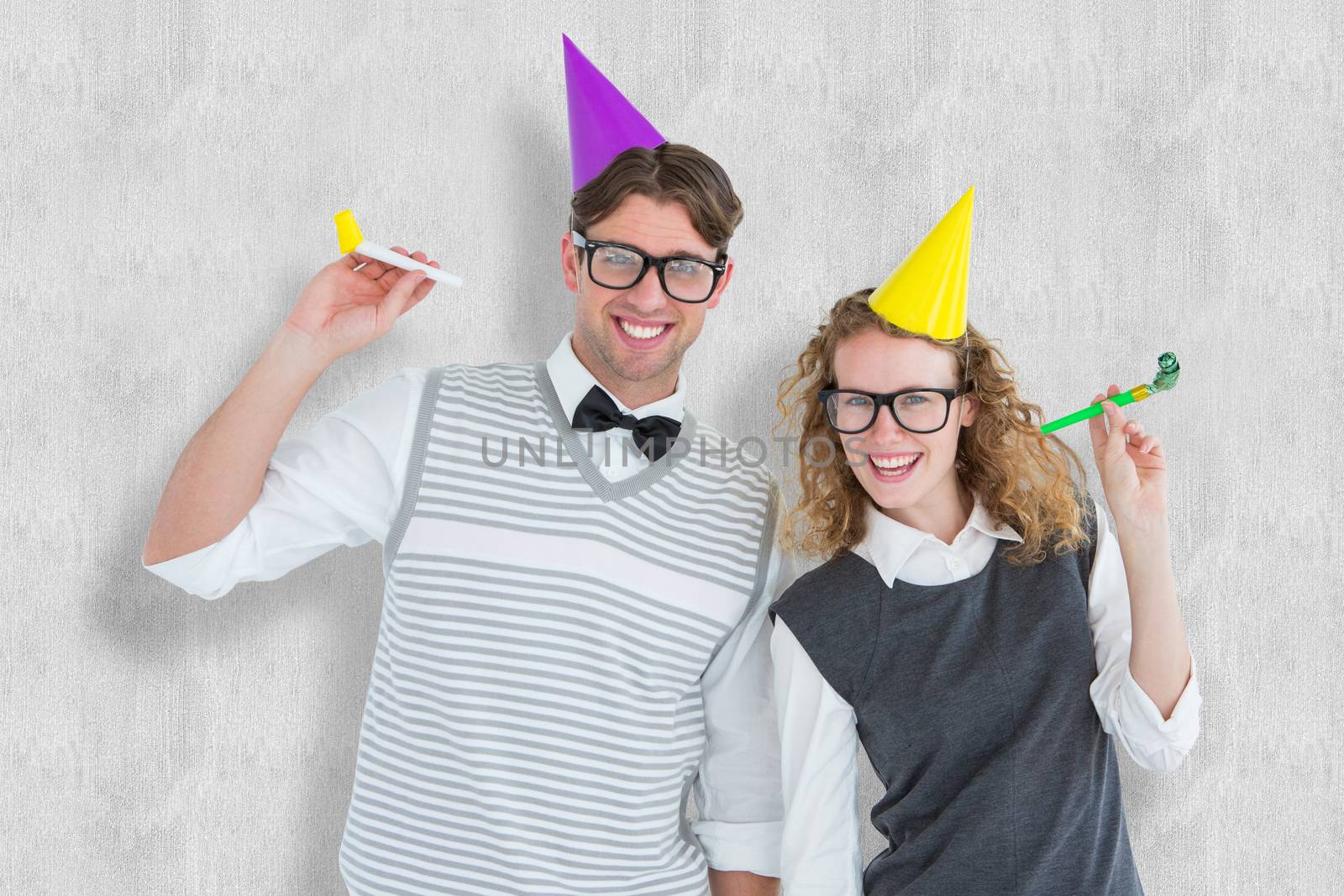 Geeky couple with party hat and party horn against white background