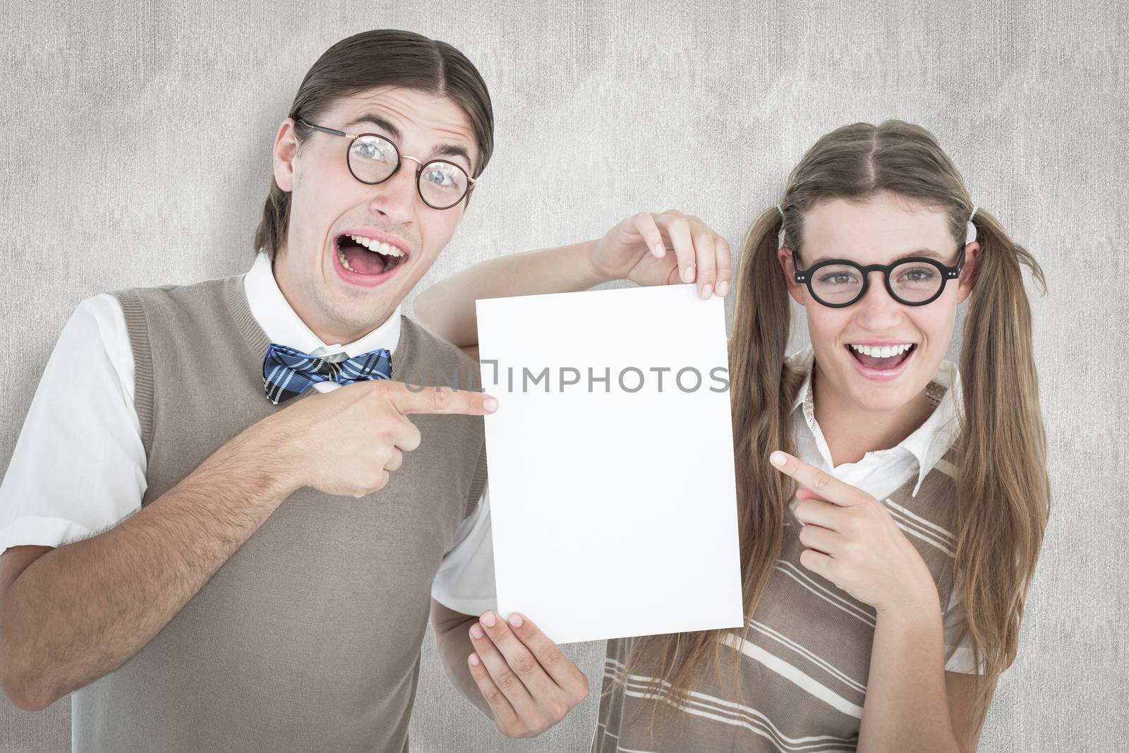 Geeky hipsters pointing at poster  against white background