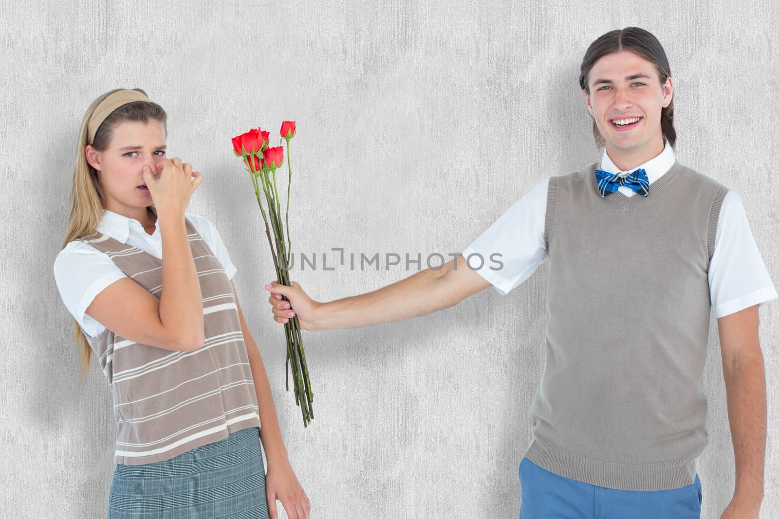 Geeky hipster offering red roses to his girlfriend  against white background