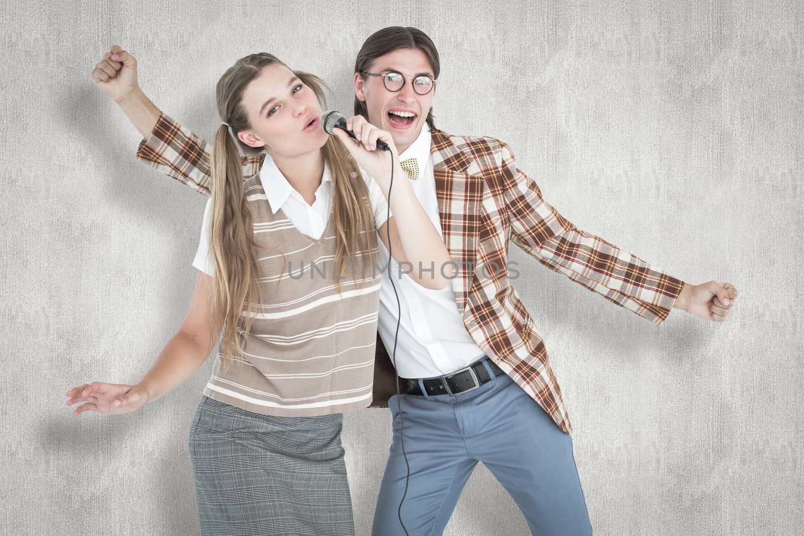Composite image of happy geeky hipsters singing with microphone by Wavebreakmedia