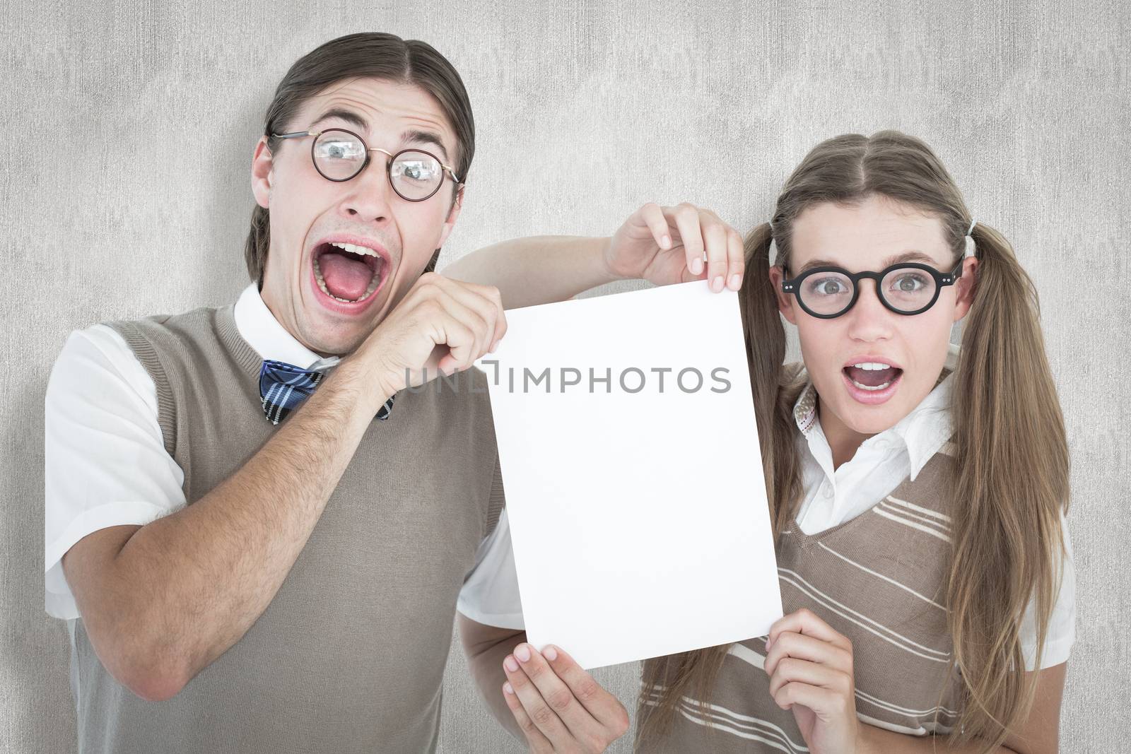 Composite image of geeky hipsters holding a poster  by Wavebreakmedia
