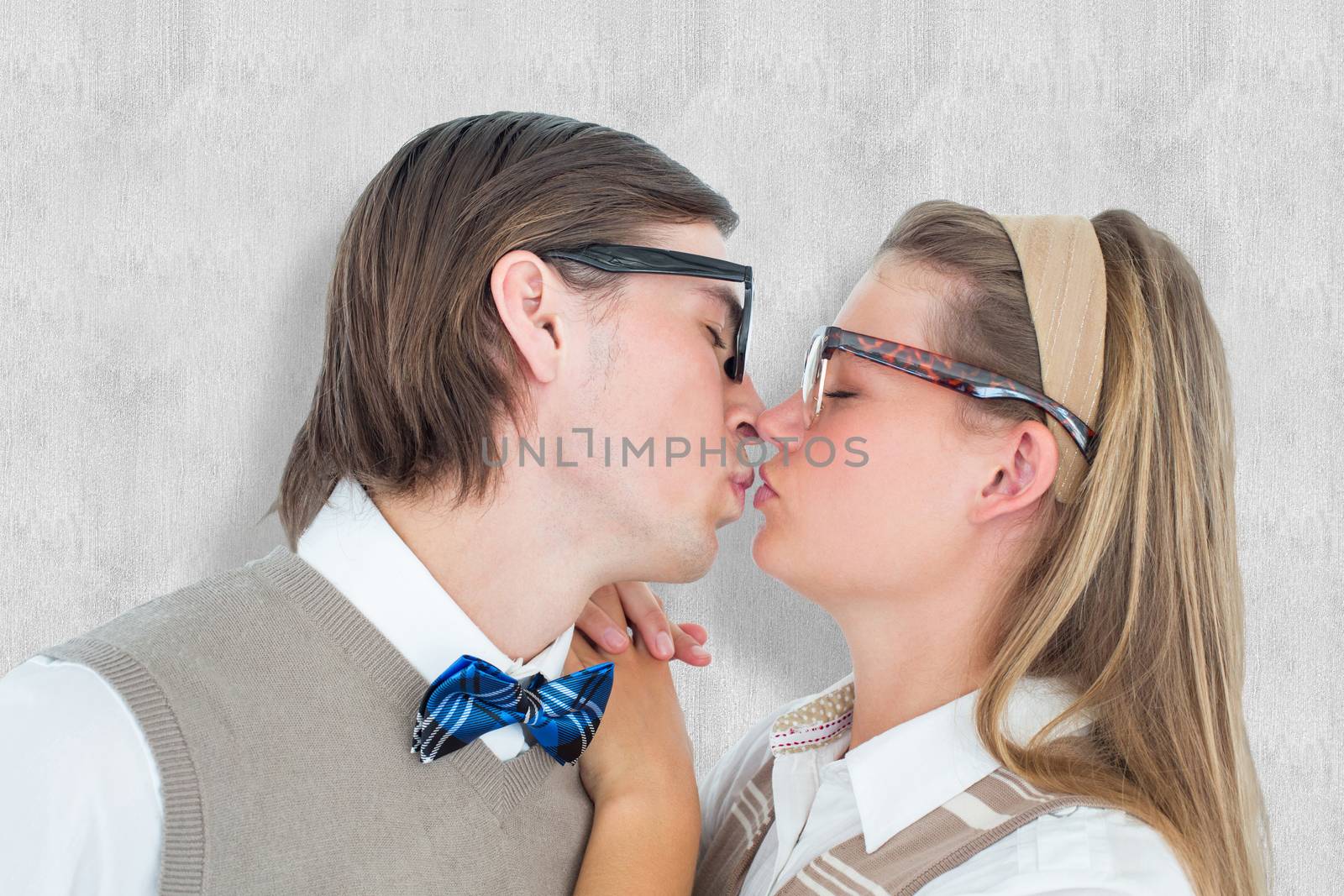 Geeky hipster couple kissing against white background