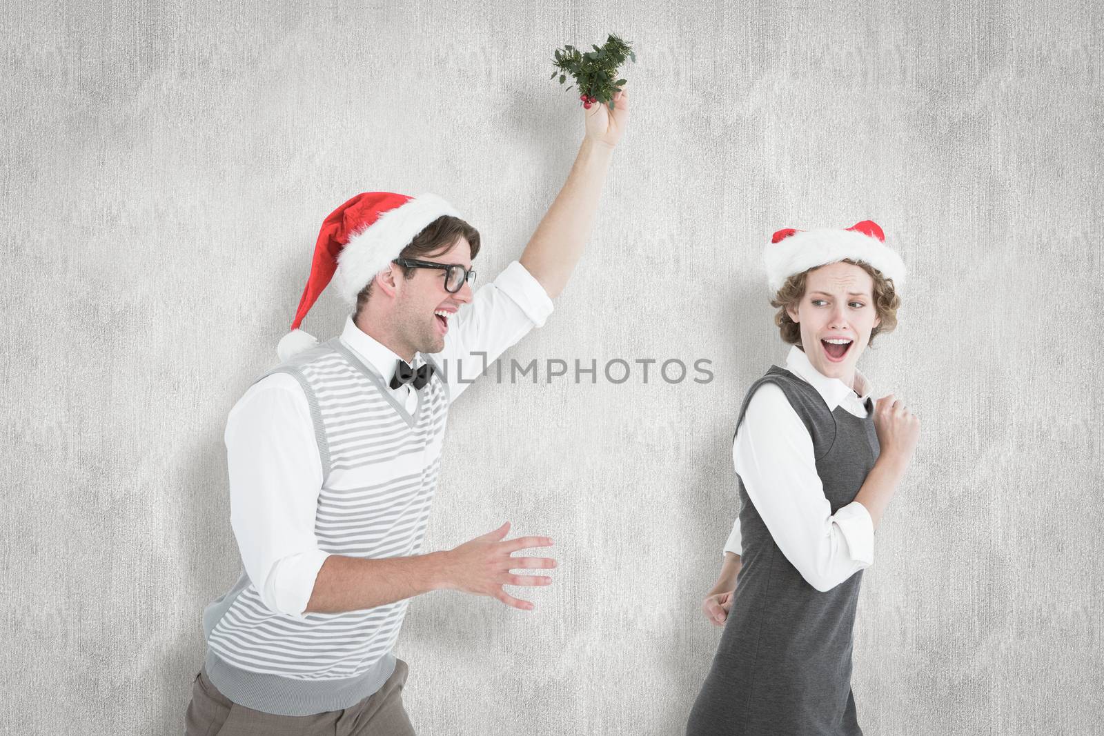 Geeky hipster running away from a man with mistletoe against white background