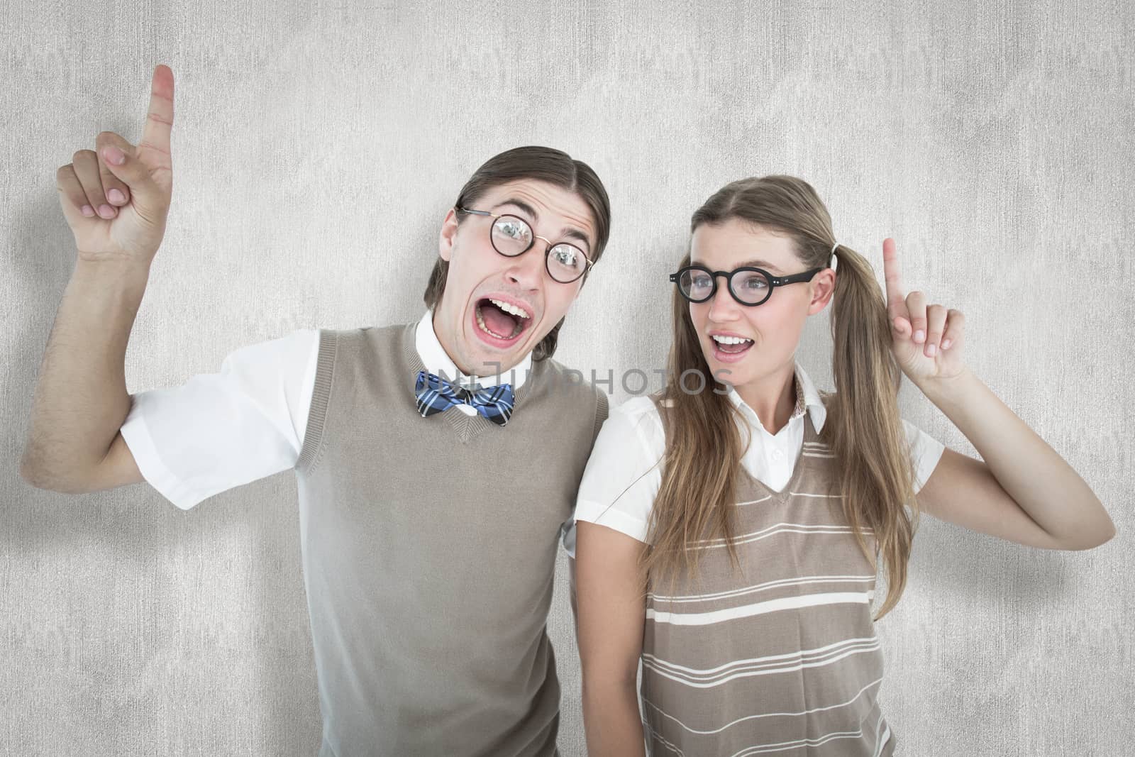 Composite image of geeky hipsters pointing by Wavebreakmedia