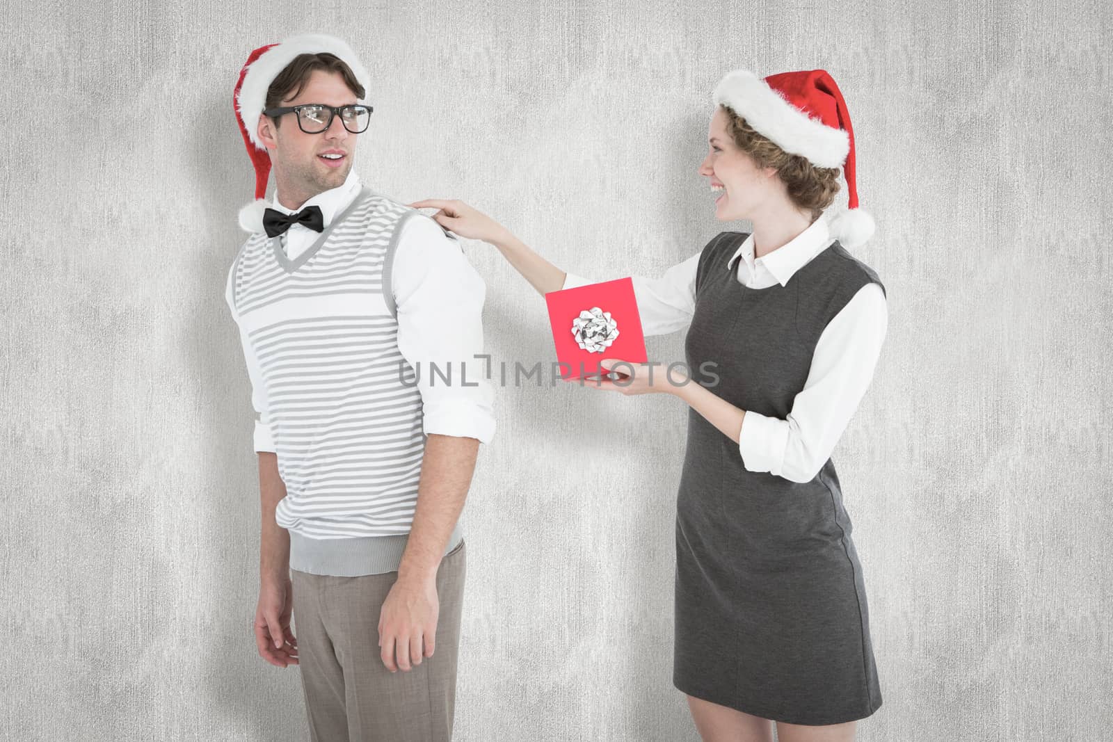 Composite image of geeky hipster offering present to her boyfriend by Wavebreakmedia