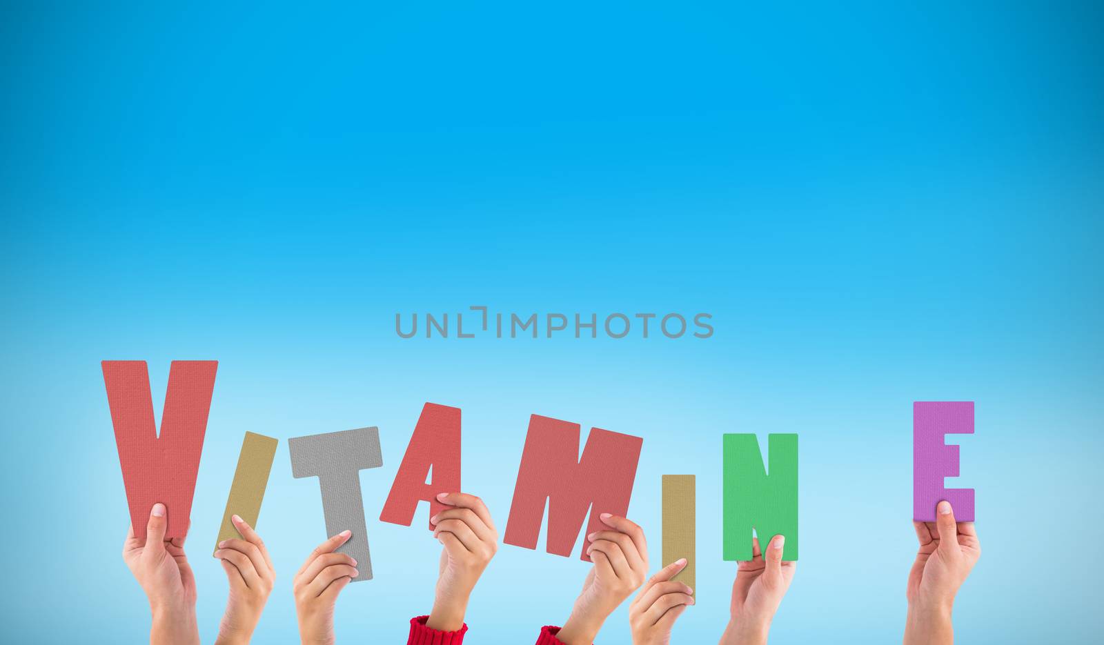 Composite image of hands holding up vitamin e by Wavebreakmedia
