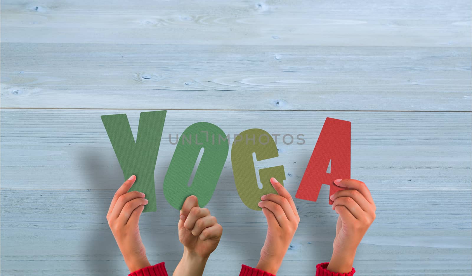 Hands holding up yoga against bleached wooden planks background