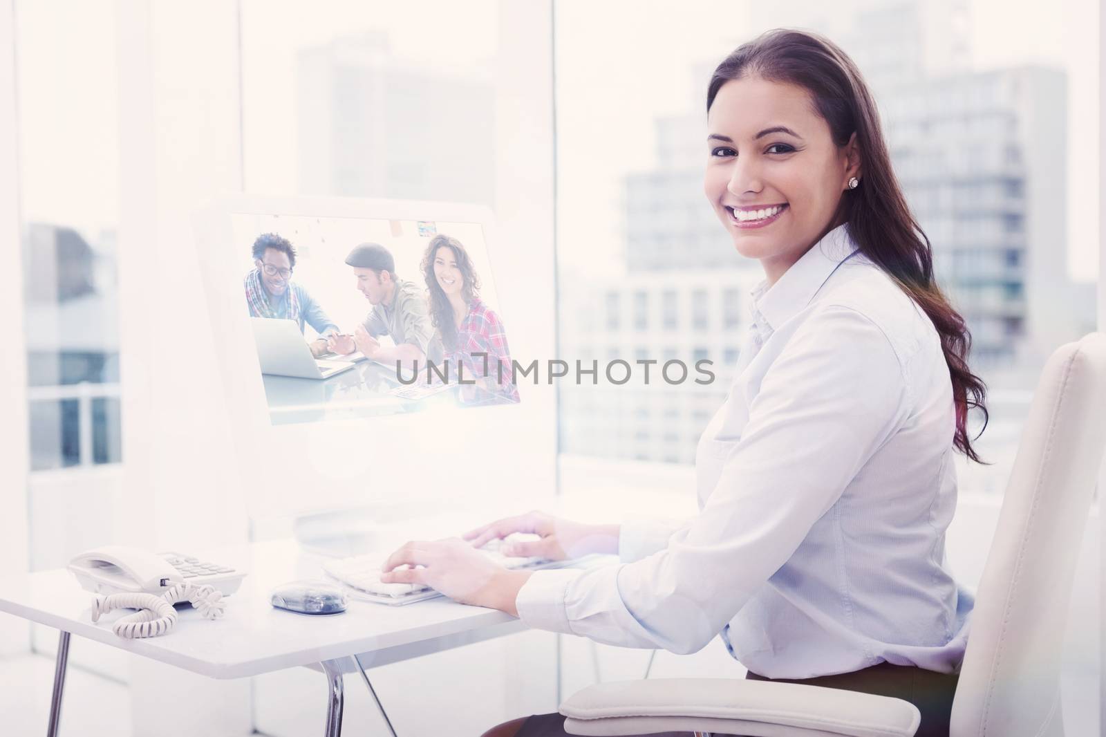 Composite image of creative team working together with one smiling at camera