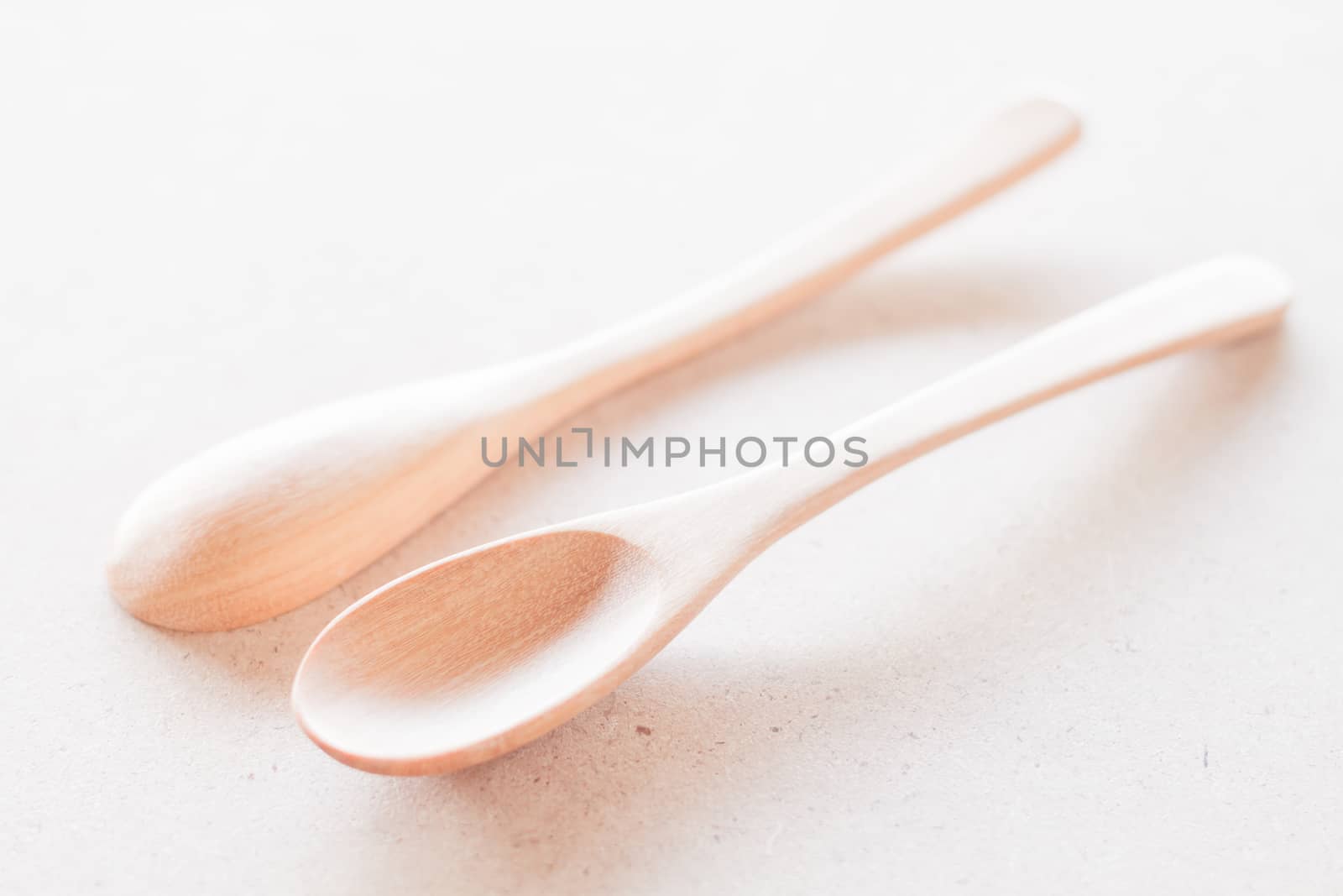 Empty spoons on wooden background by punsayaporn