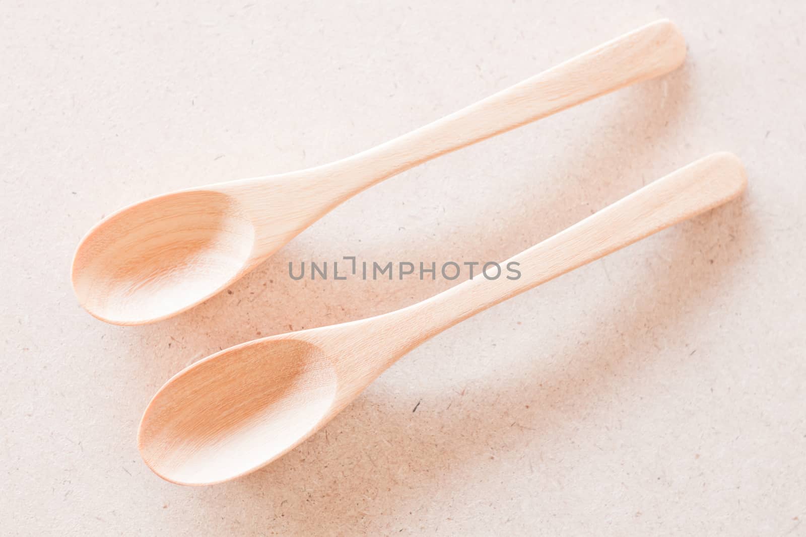 Top view of wooden spoons on brown background by punsayaporn