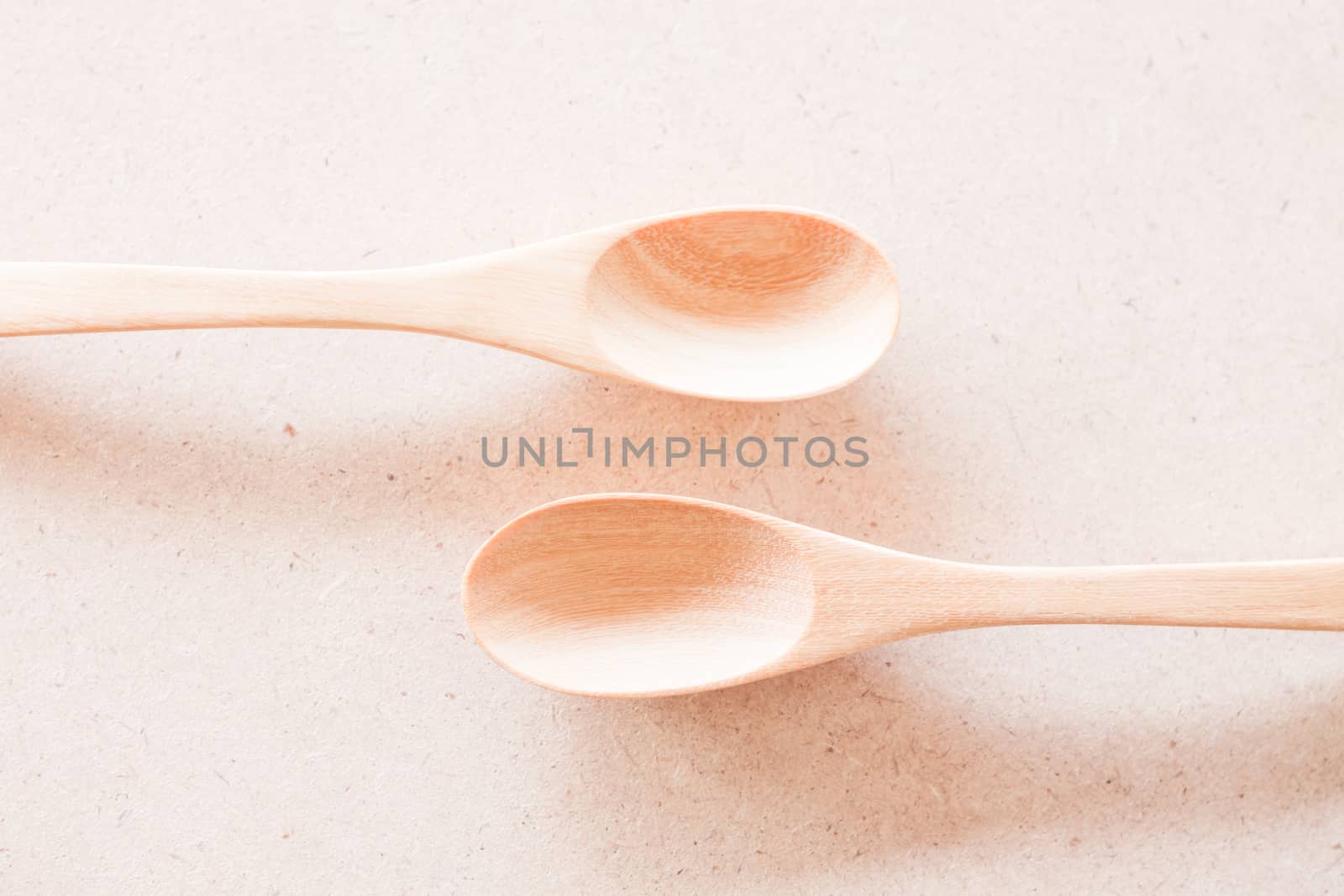 New wooden spoons on brown background, stock photo