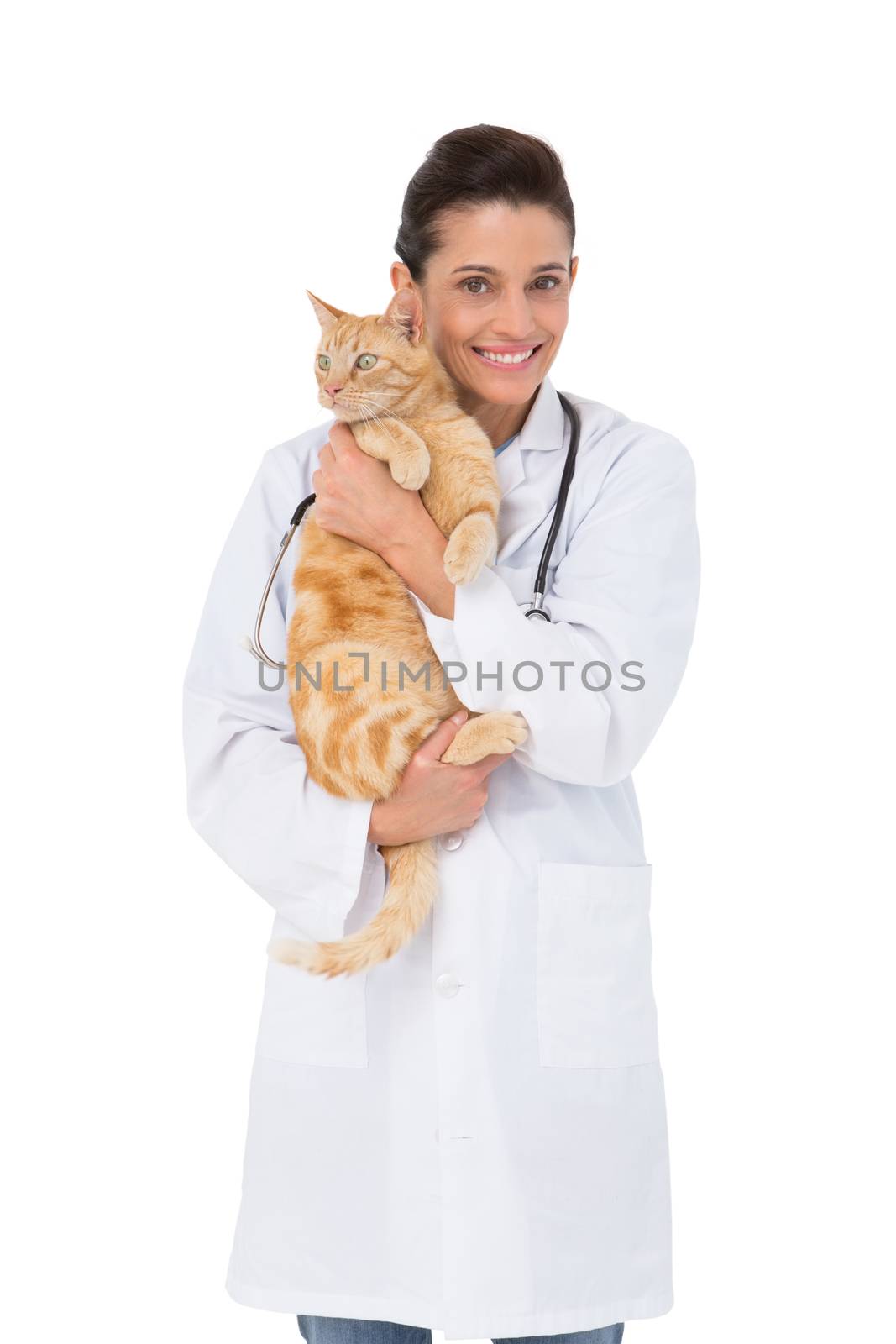 Smiling veterinarian with a cute kitten in her arms in medical office